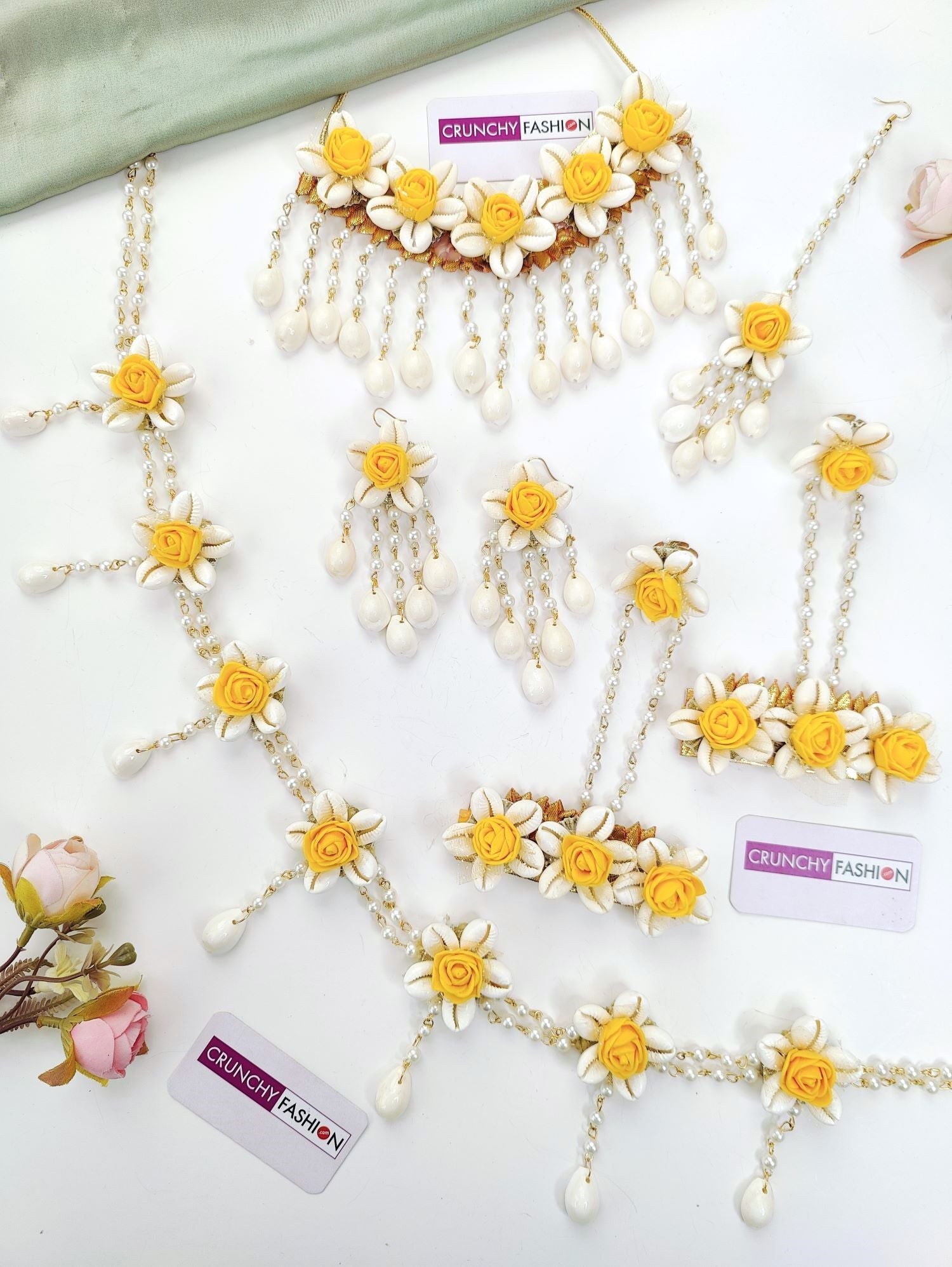 Yellow shell-made ethnic flower-themed jewellery set for baby shower featuring necklace, earrings, and maang tikka