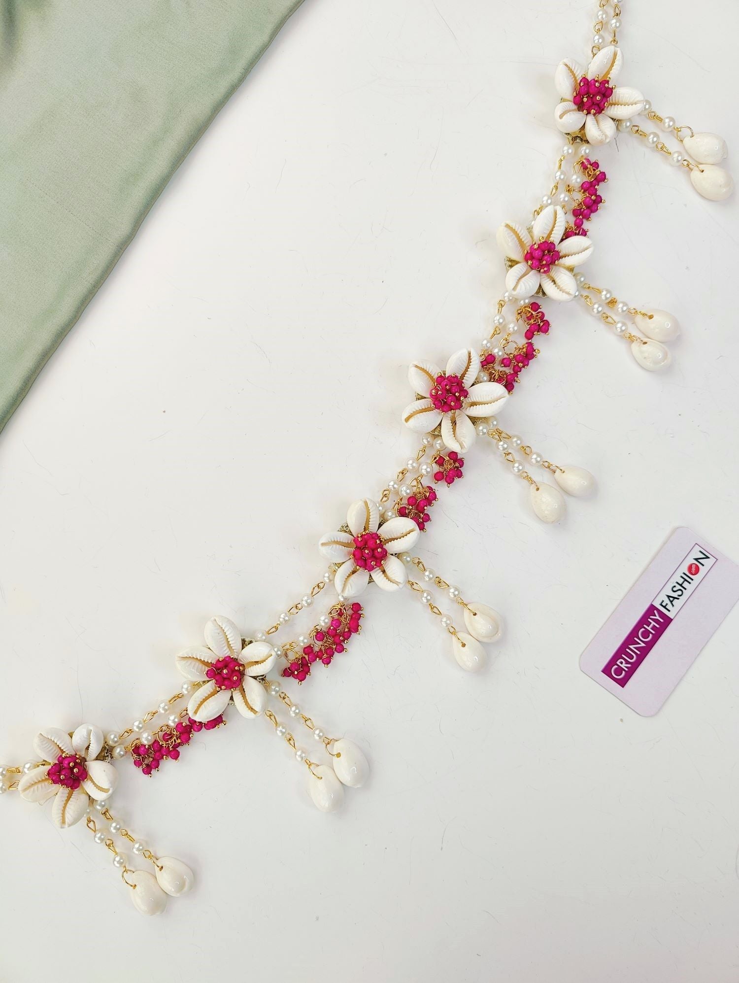 Pink flower-themed ethnic jewellery set ideal for baby shower and maternity shoot, includes necklace, earrings, and maang tikka.