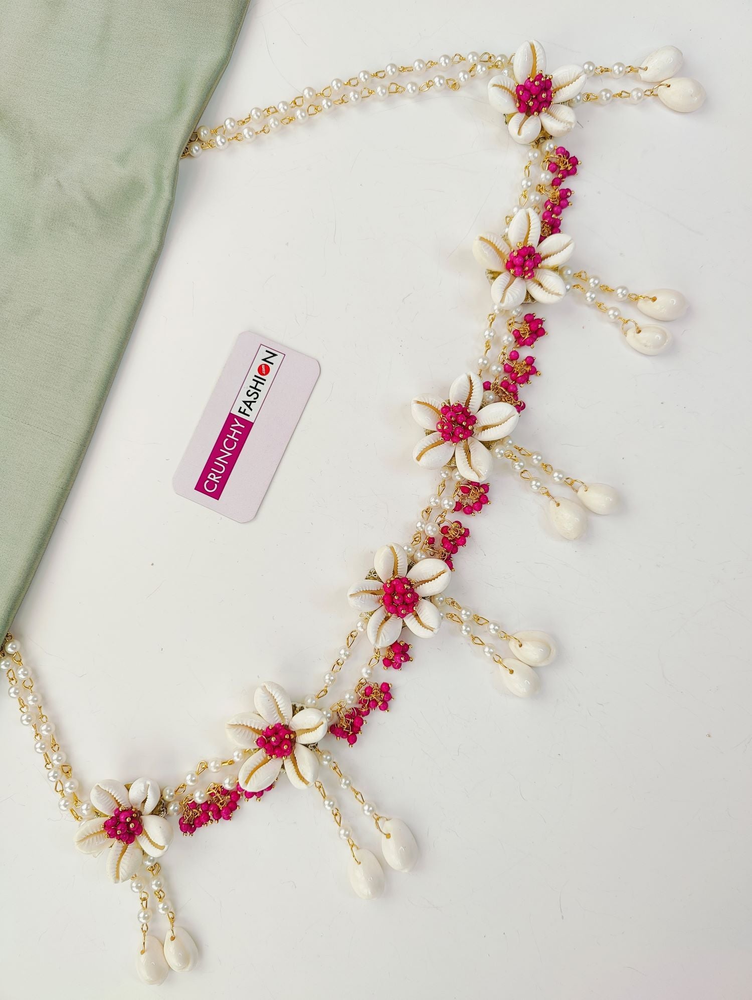 Pink flower-themed ethnic jewellery set ideal for baby shower and maternity shoot, includes necklace, earrings, and maang tikka.