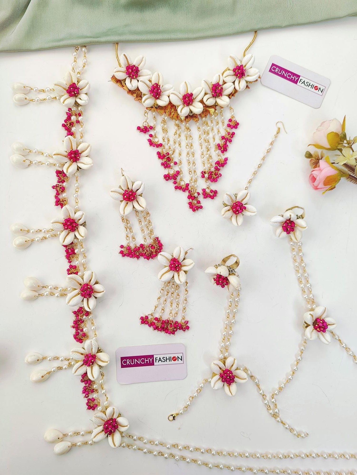Pink flower-themed ethnic jewellery set ideal for baby shower and maternity shoot, includes necklace, earrings, and maang tikka.