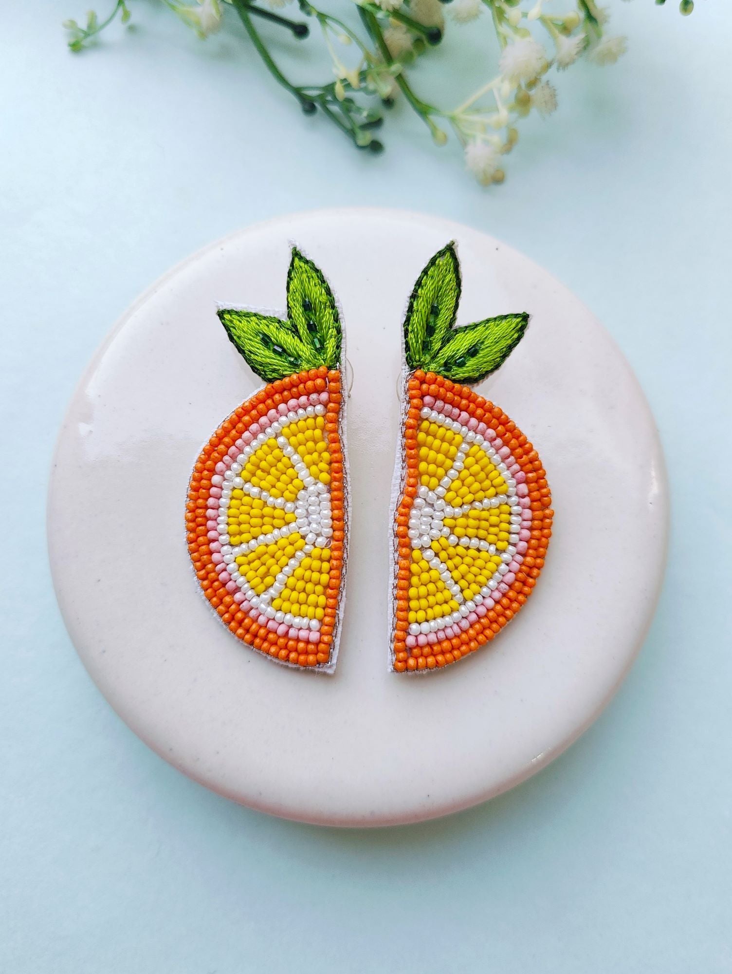 Handcrafted, ethnic orange beaded stud earrings designed for festive occasions and weddings. These lightweight, vibrant orange slice earrings are crafted for mesmerizing elegance.