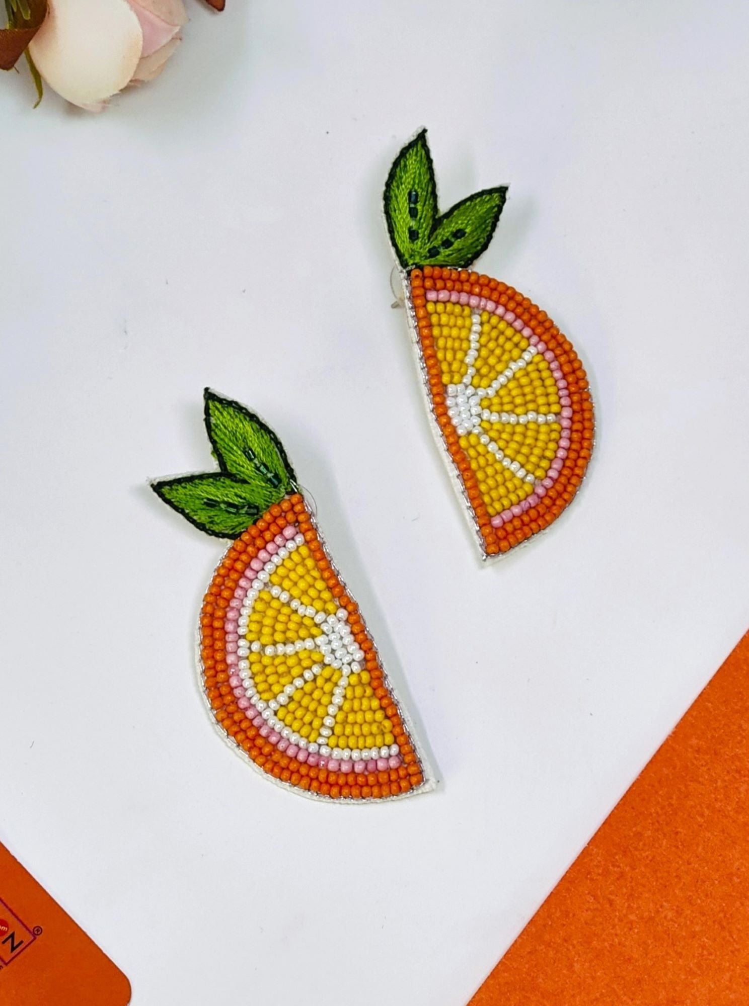 Handcrafted, ethnic orange beaded stud earrings designed for festive occasions and weddings. These lightweight, vibrant orange slice earrings are crafted for mesmerizing elegance.