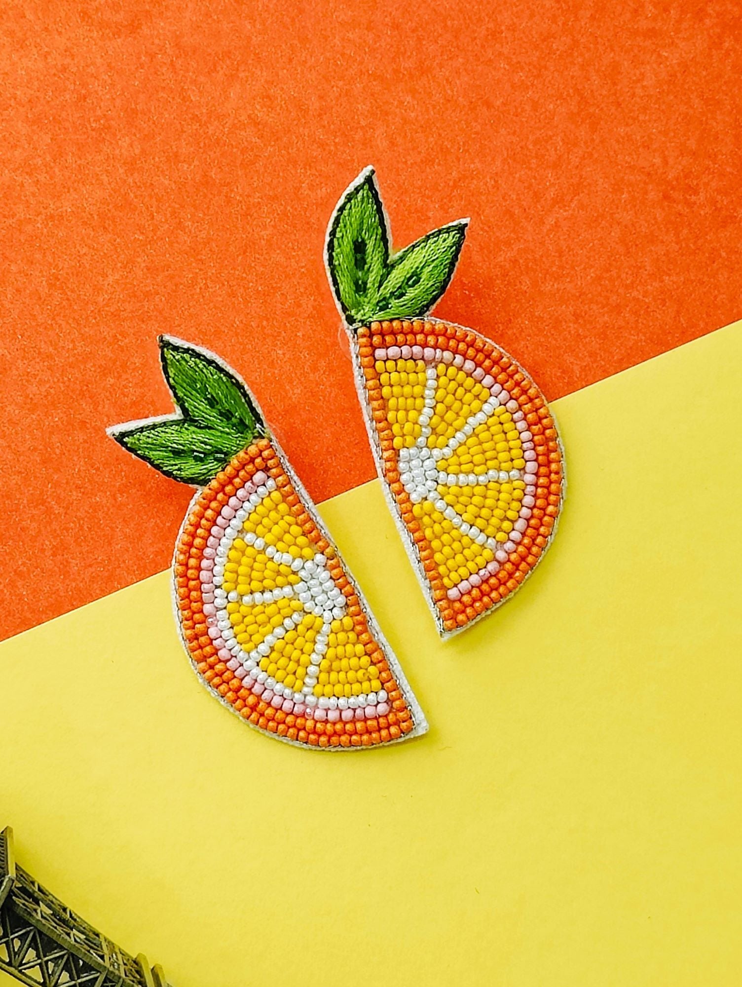 Handcrafted, ethnic orange beaded stud earrings designed for festive occasions and weddings. These lightweight, vibrant orange slice earrings are crafted for mesmerizing elegance.