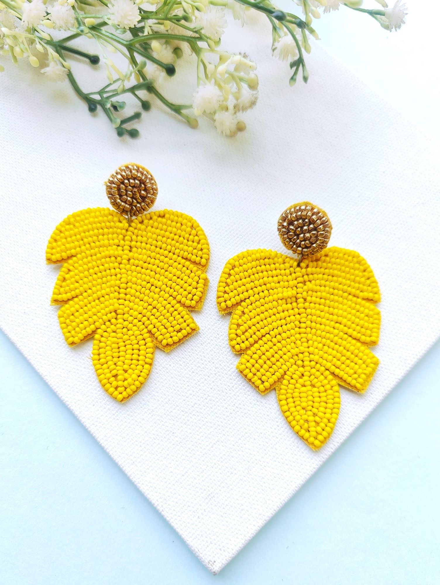 Handicraft collection beaded handmade earrings in leaf shape, vibrant yellow in color, ideal for women and girls to wear in daily life, festivals, or birthdays.
