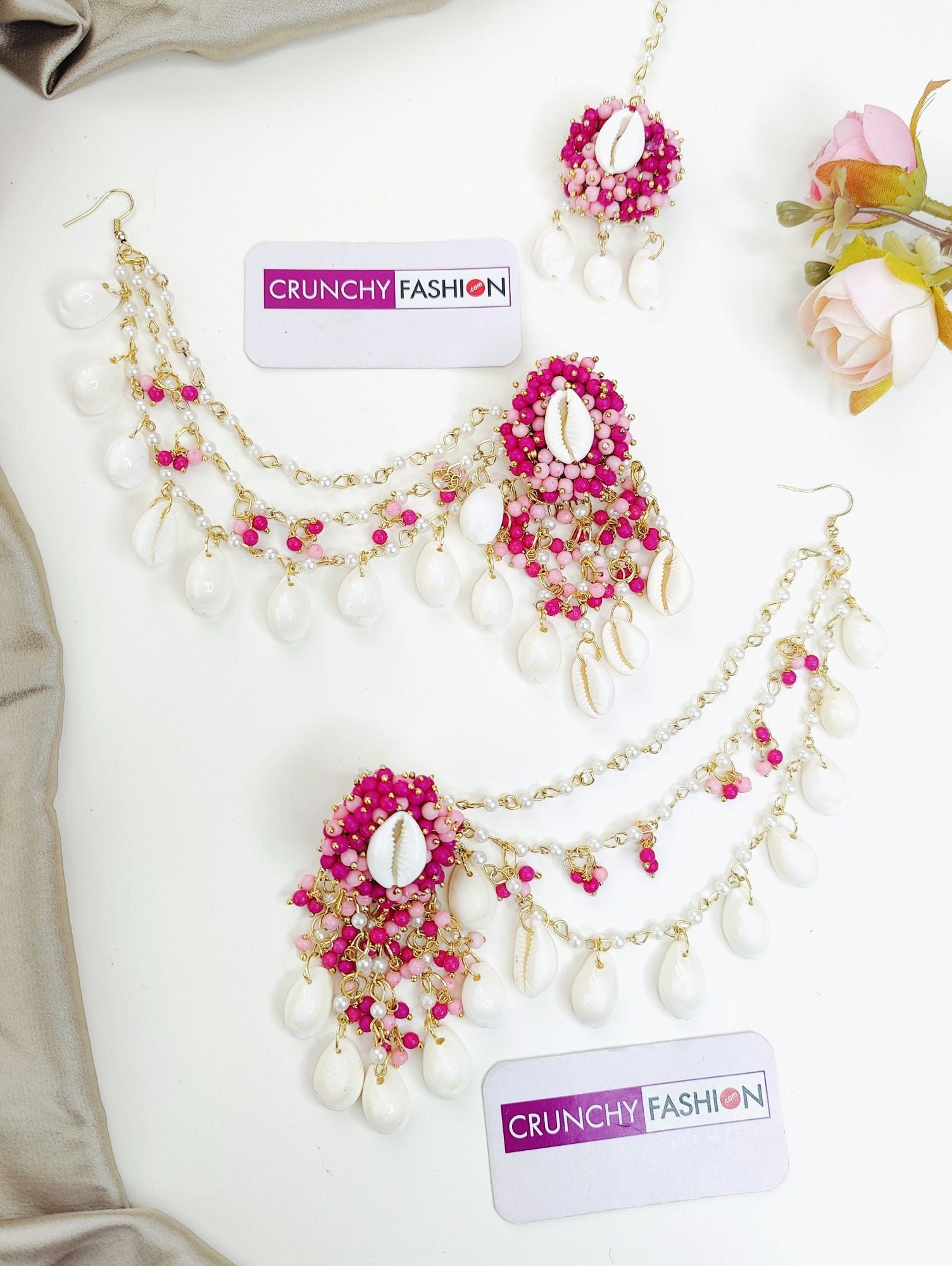 pink imitation jewelry set, featuring handmade pearl and shell jhumka earrings, paired with maang tikka for women's haldi.