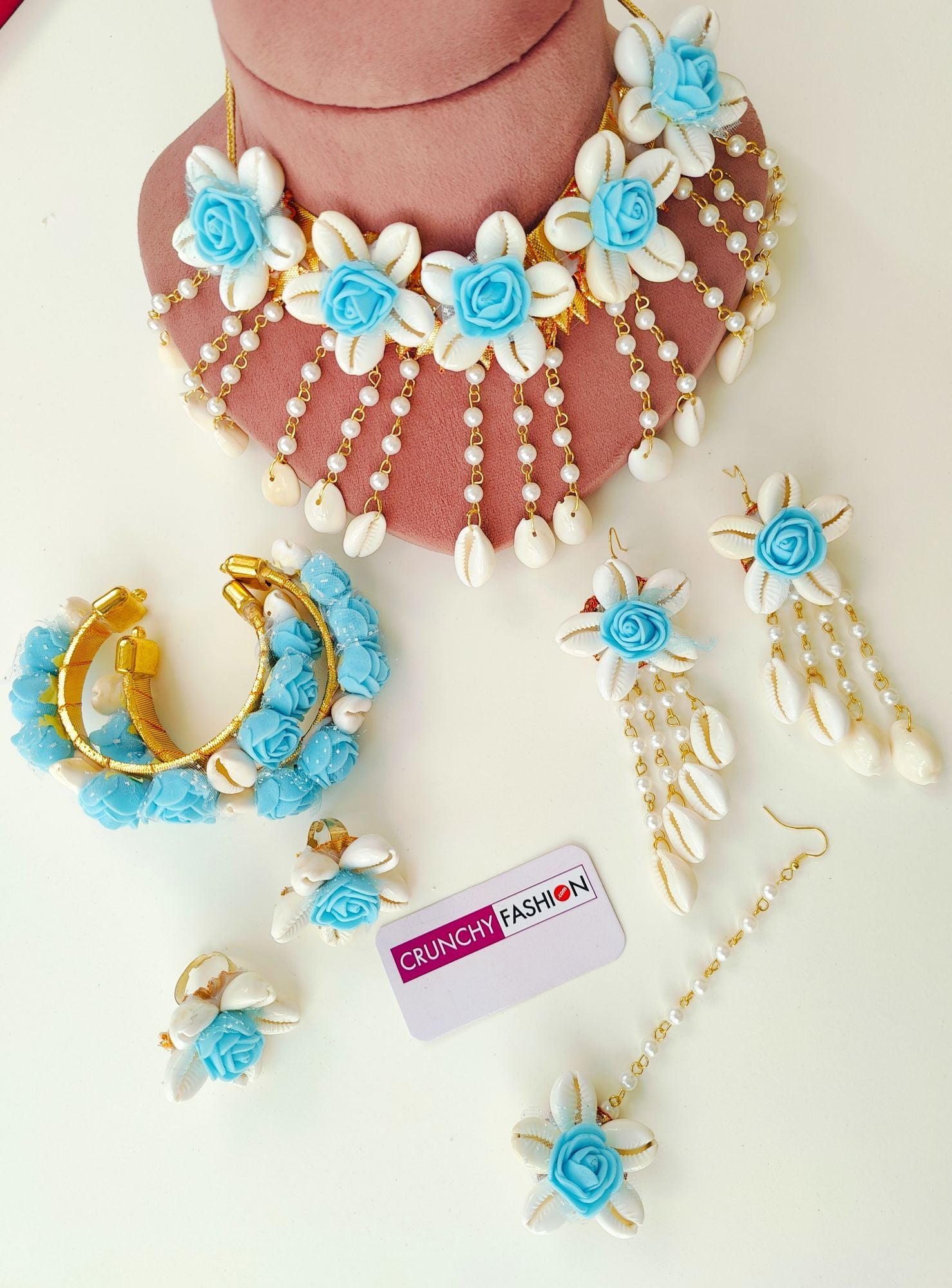 Aqua blue flower-themed, handmade cowrie shell bridal jewellery set, ideal for haldi and wedding occasions