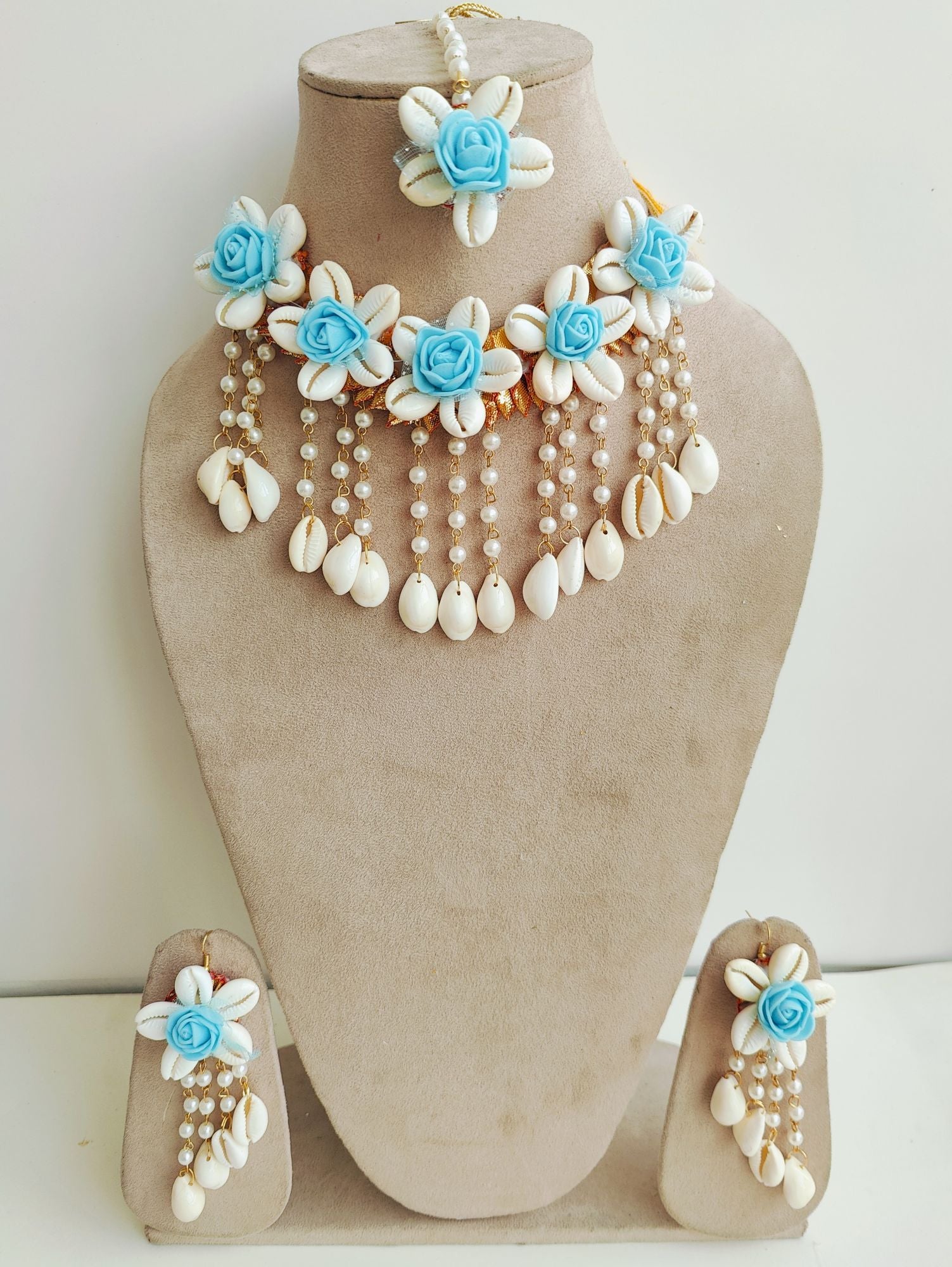 Aqua blue flower-themed, handmade cowrie shell bridal jewellery set, ideal for haldi and wedding occasions