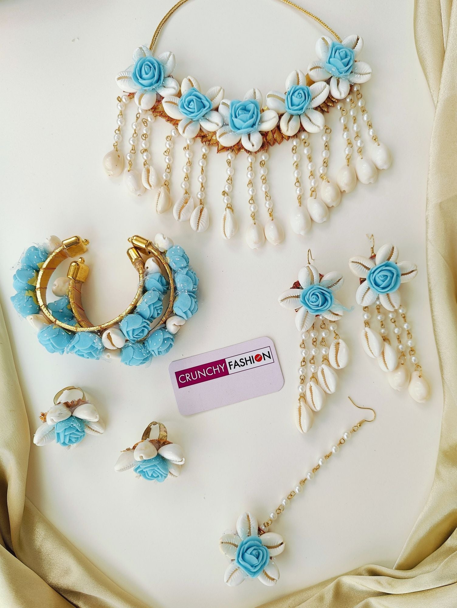 Aqua blue flower-themed, handmade cowrie shell bridal jewellery set, ideal for haldi and wedding occasions
