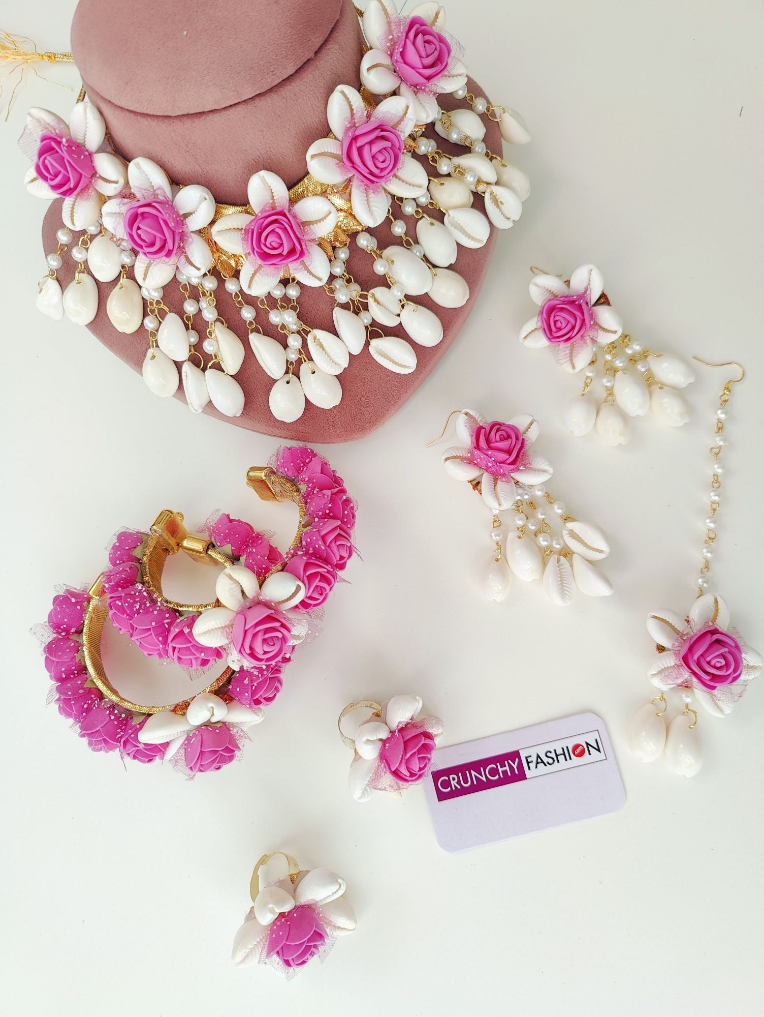 Handmade pink flower and cowrie shell bridal jewellery set, perfect for haldi and mehndi occasions
