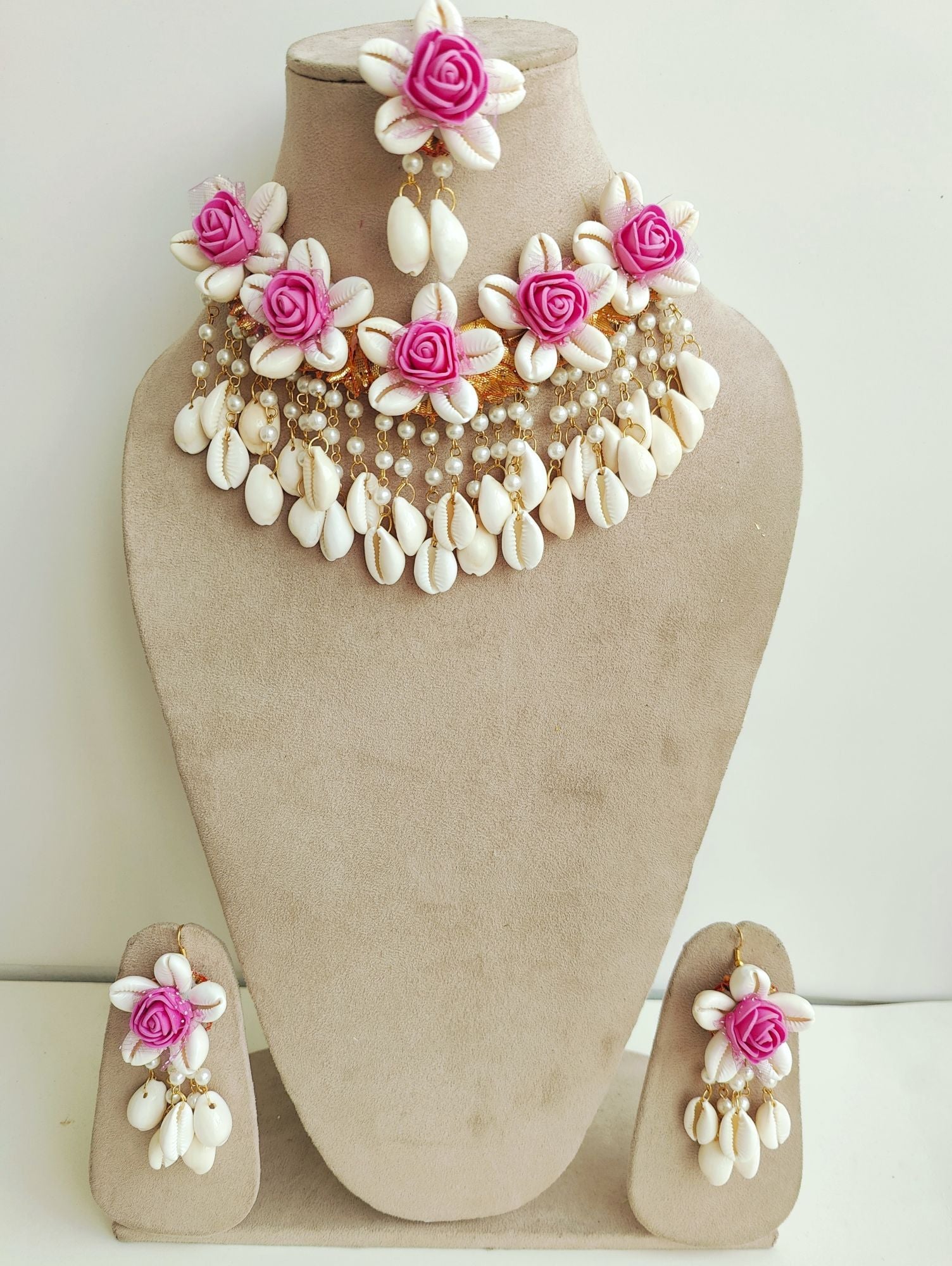 Handmade pink flower and cowrie shell bridal jewellery set, perfect for haldi and mehndi occasions