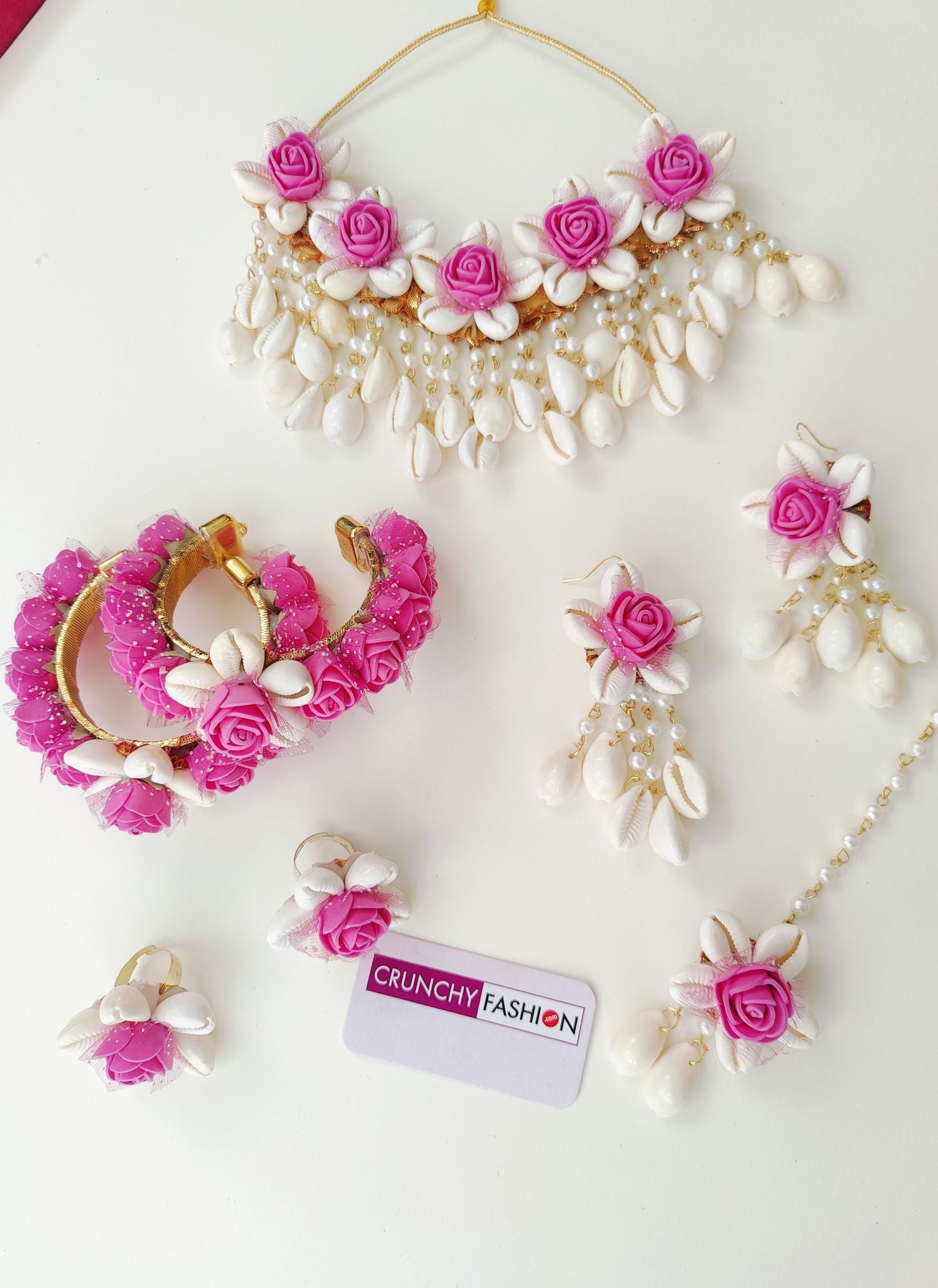 Handmade pink flower and cowrie shell bridal jewellery set, perfect for haldi and mehndi occasions
