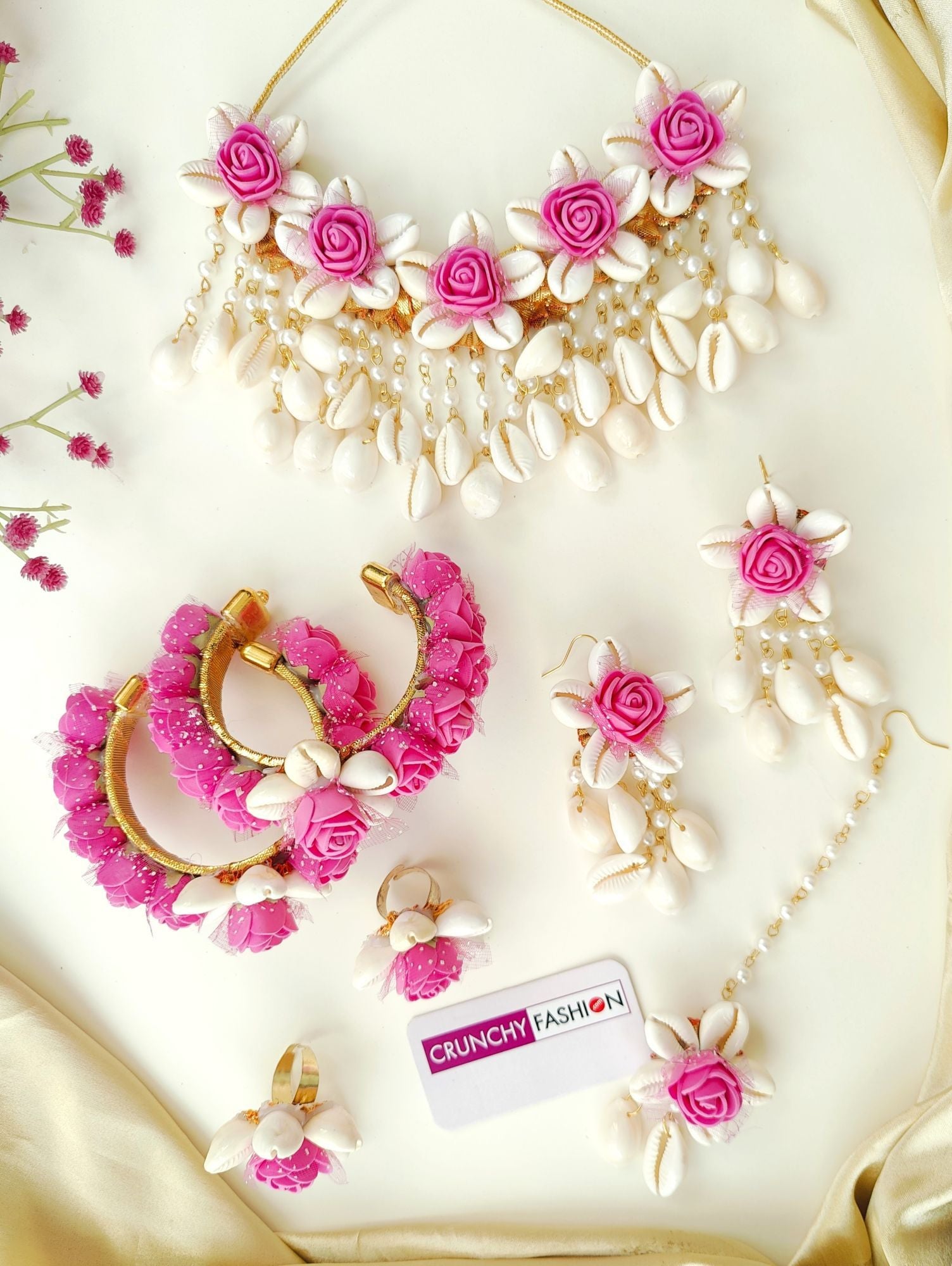 Handmade pink flower and cowrie shell bridal jewellery set, perfect for haldi and mehndi occasions