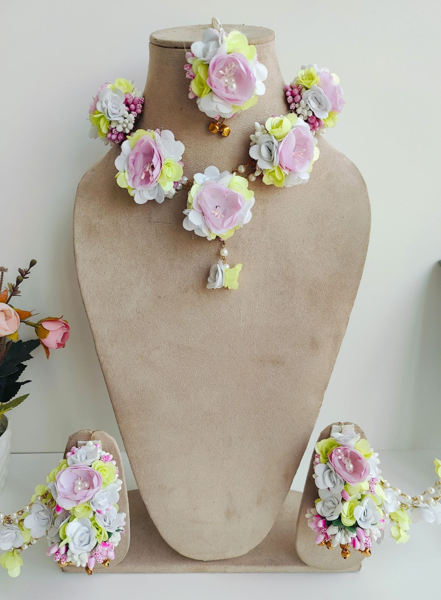 Floral-themed pastel pink and light green artificial flower jewellery set, ideal for women at Mehandi ceremonies