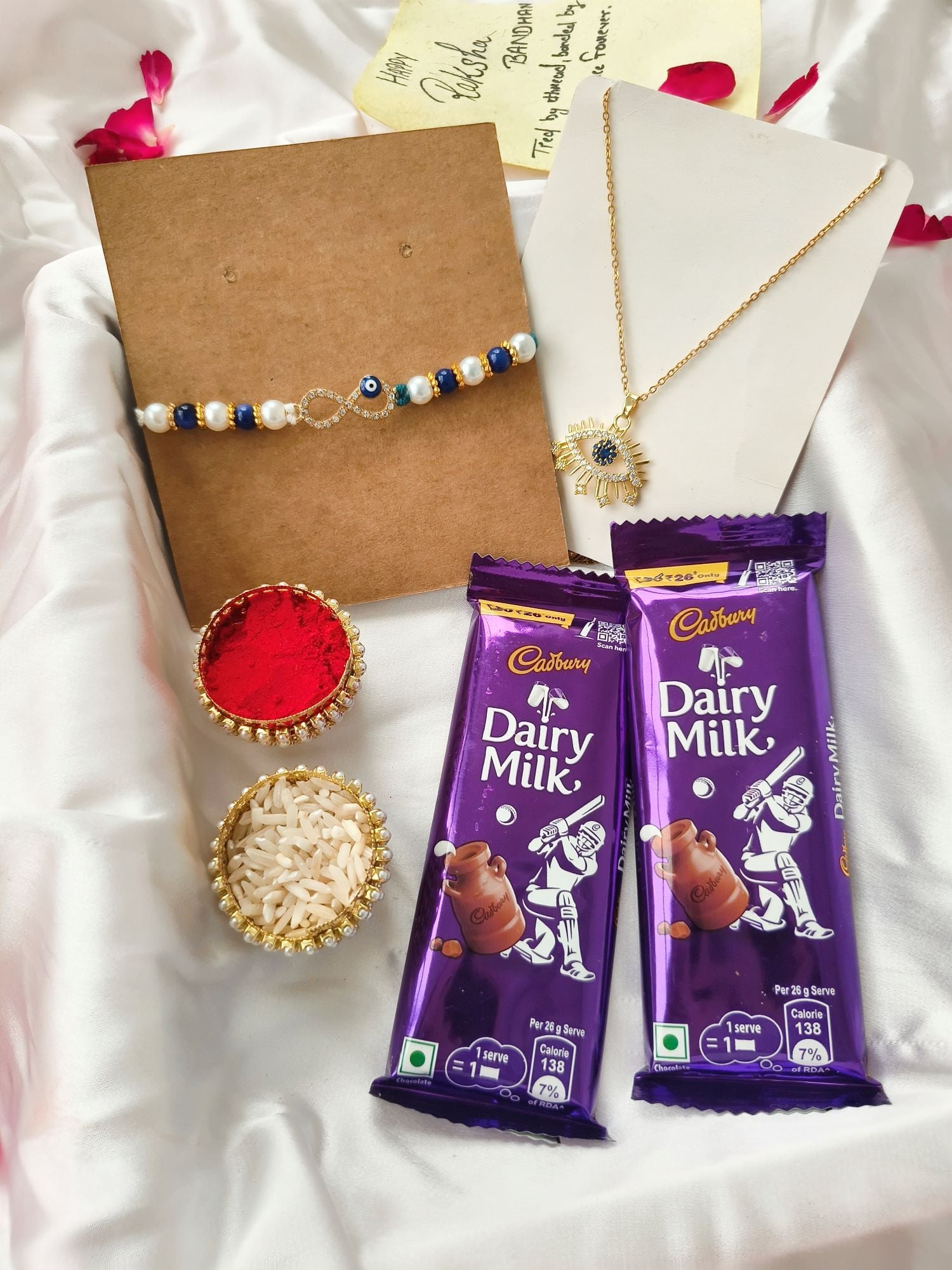Rakhi hamper with evil eye rakhi, roli chawal and Dairy Milk