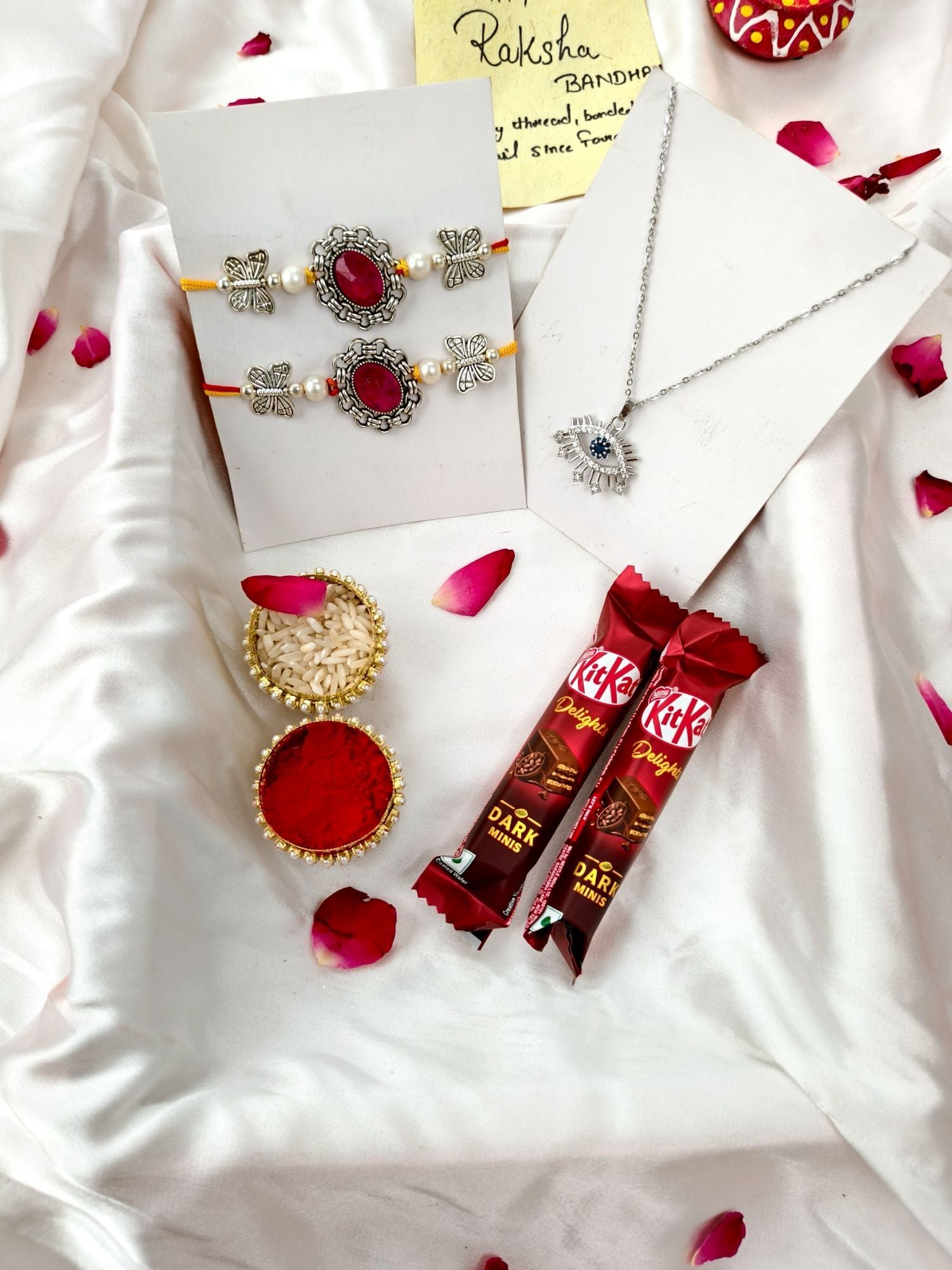Red stone silver rakhi hamper set of 2 with chocolate for brother