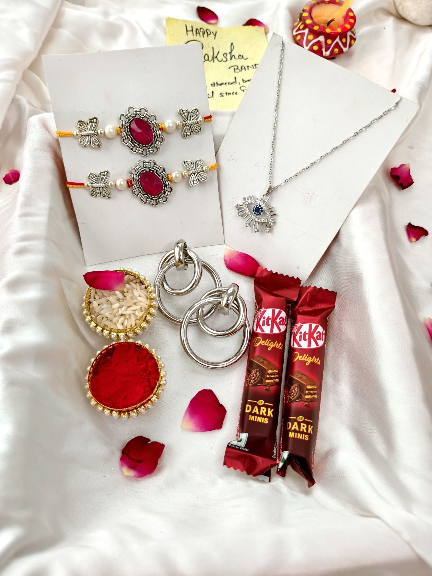 Red stone silver rakhi hamper set of 2 with chocolate for brother