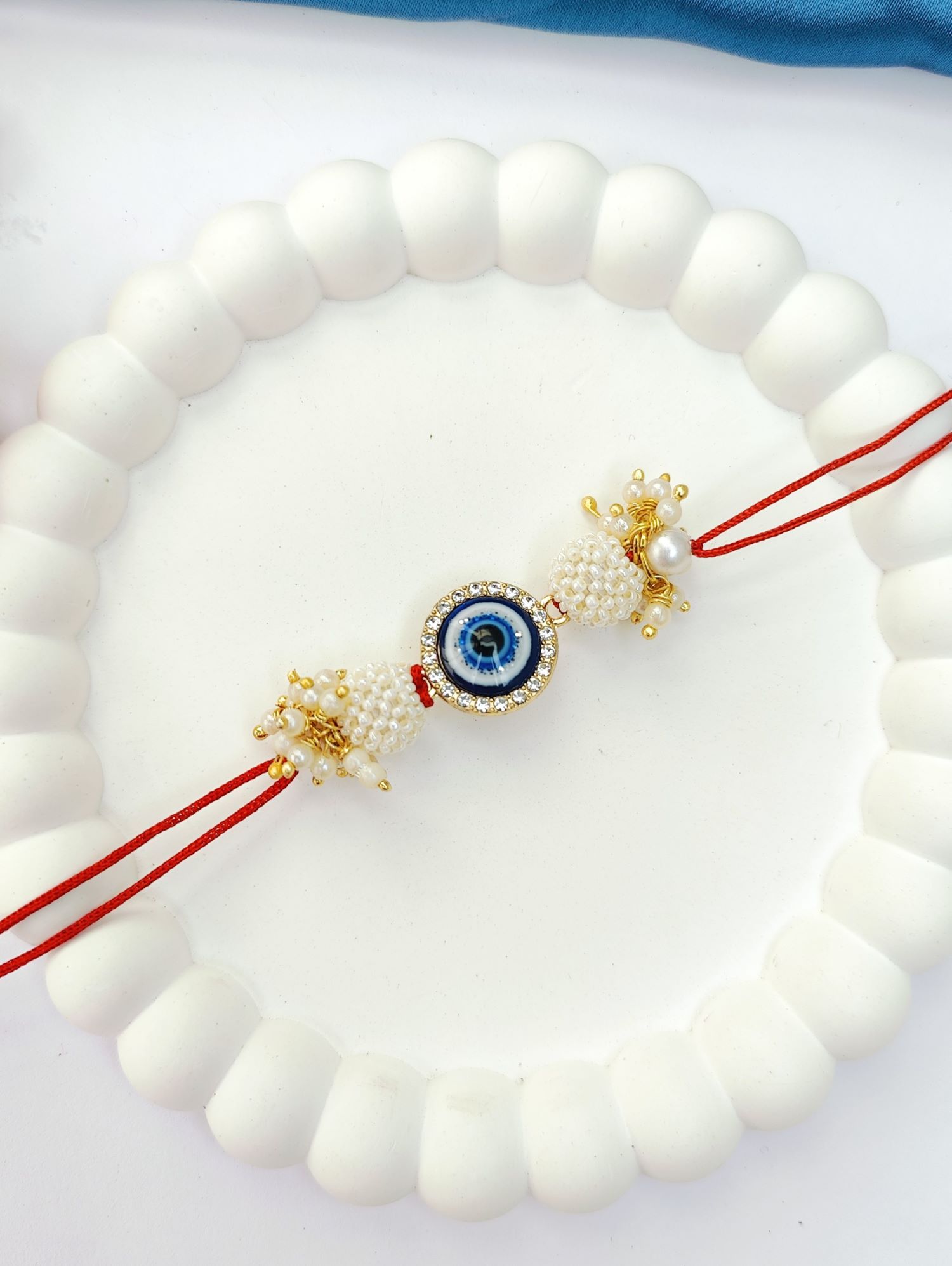 blue handmade evil eye rakhi set for bhaiya bhabhi, pearl beads