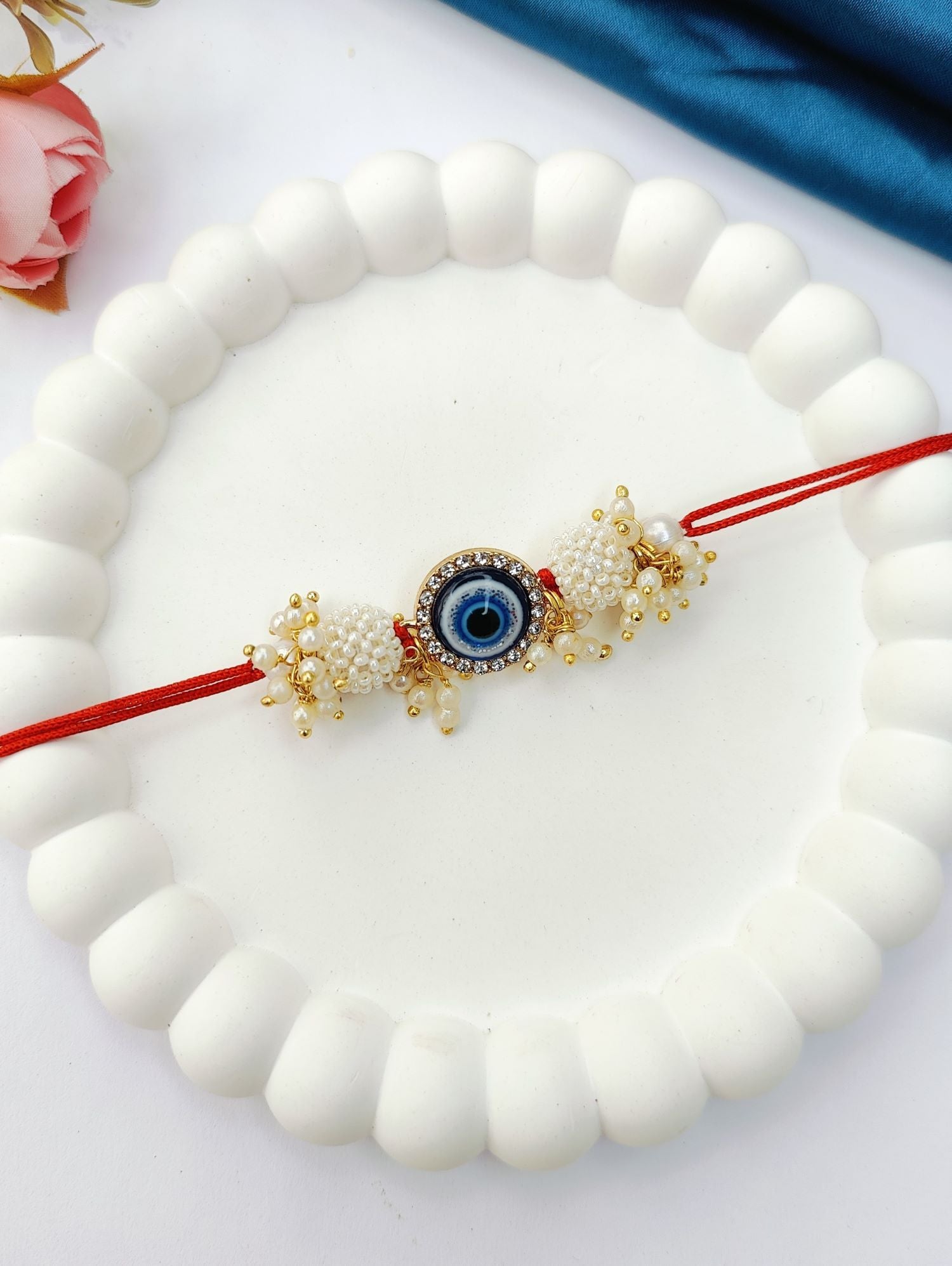 blue handmade evil eye rakhi set for bhaiya bhabhi, pearl beads