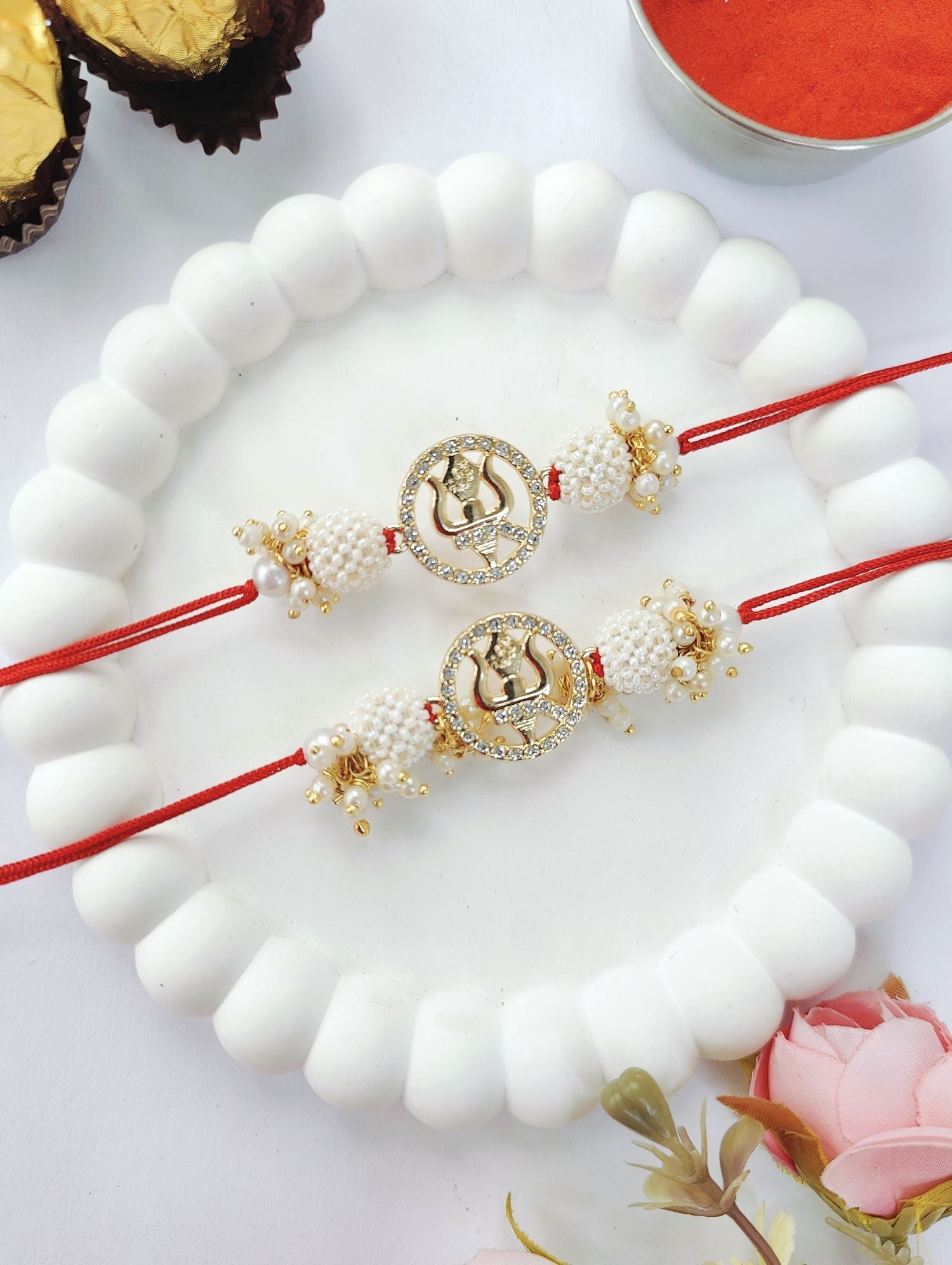 white couple set trishul rakhi design with pearl bead rakhi for bhaiya bhabhi 2026