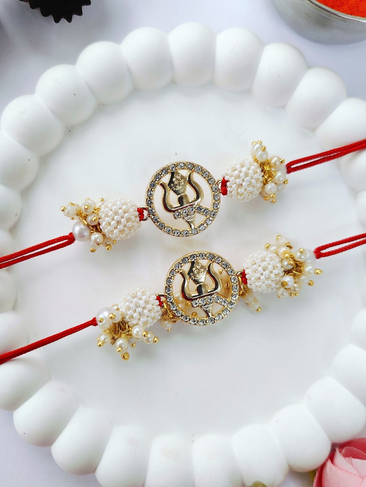 white couple set trishul rakhi design with pearl bead rakhi for bhaiya bhabhi 2026