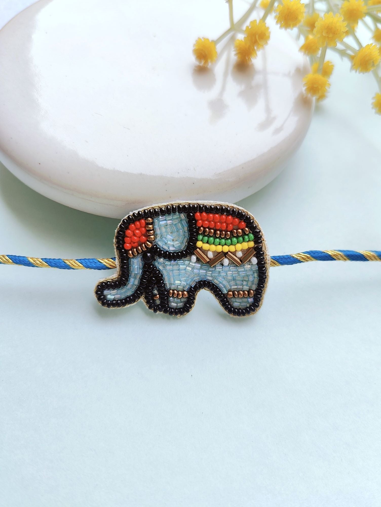 Multicolor, handmade, beaded Rakhi for kids ideal for Raksha Bandhan occasion, comes in a package with Roli and Chawal