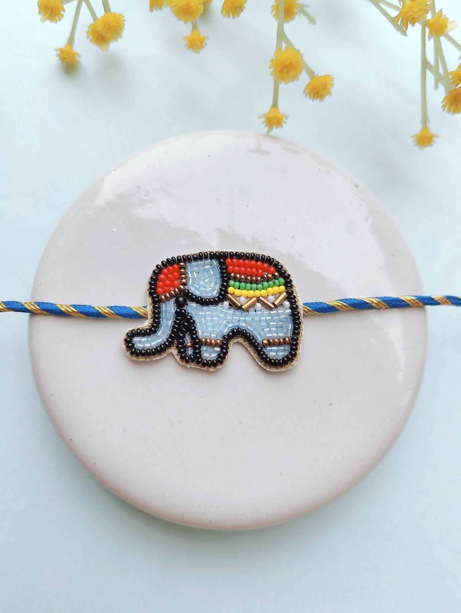 Multicolor, handmade, beaded Rakhi for kids ideal for Raksha Bandhan occasion, comes in a package with Roli and Chawal