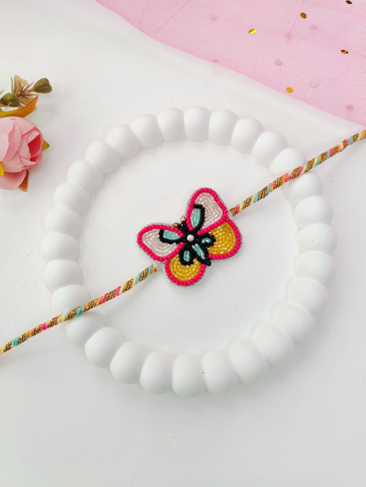 Rich pink handmade rakhi with cute butterfly tassel, kids rakhi 2026