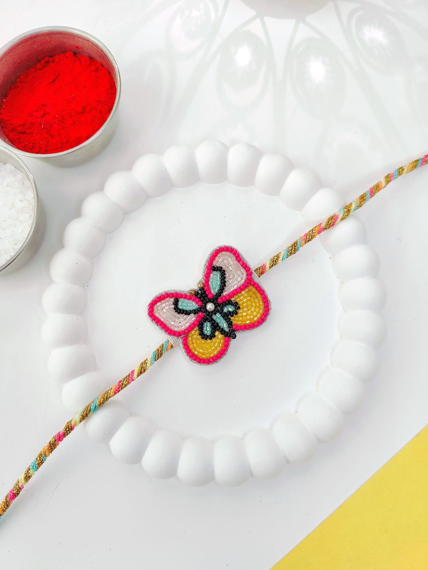 Rich pink handmade rakhi with cute butterfly tassel, kids rakhi 2026