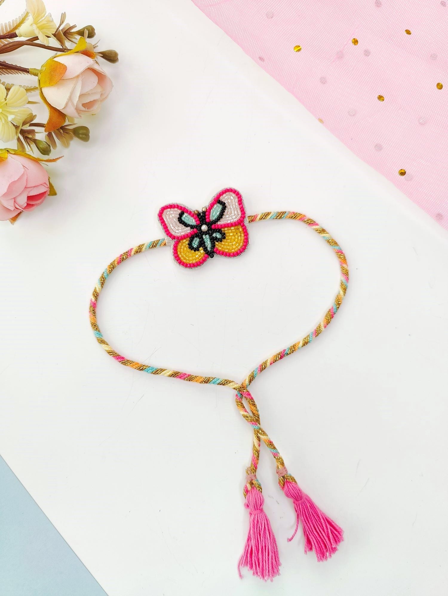 Rich pink handmade rakhi with cute butterfly tassel, kids rakhi 2026
