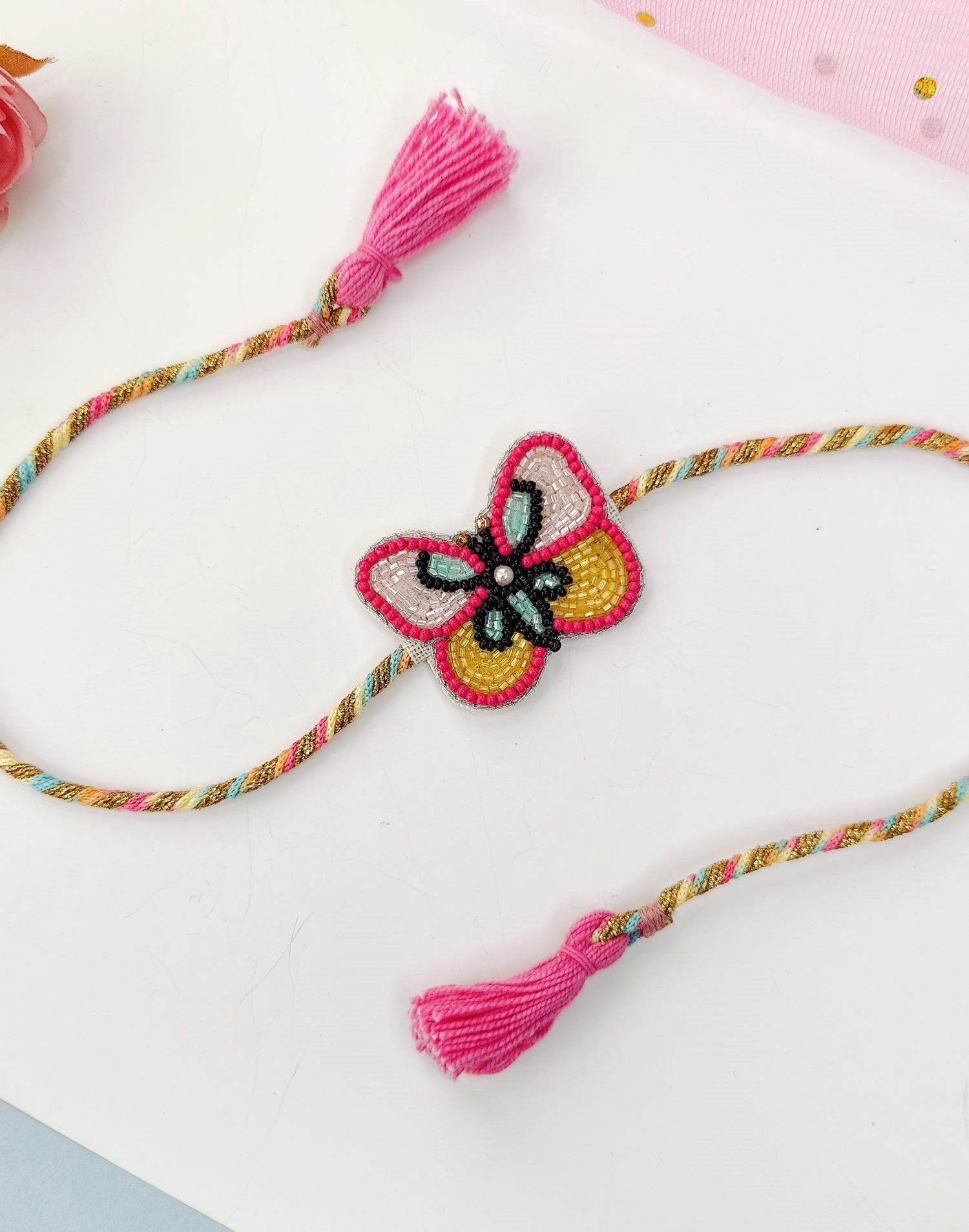 Rich pink handmade rakhi with cute butterfly tassel, kids rakhi 2026