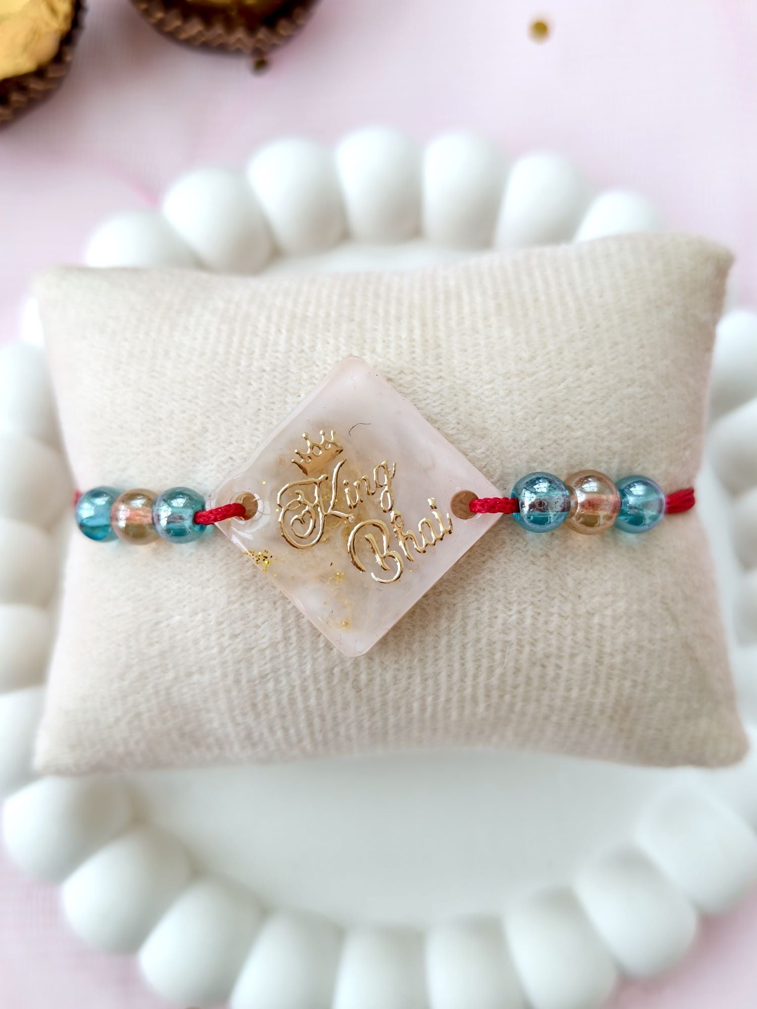 handmade resin rakhi king bhai design with pearl bead for brother