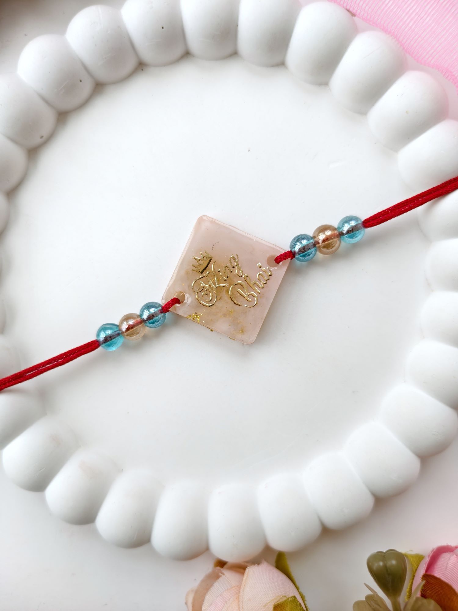 handmade resin rakhi king bhai design with pearl bead for brother