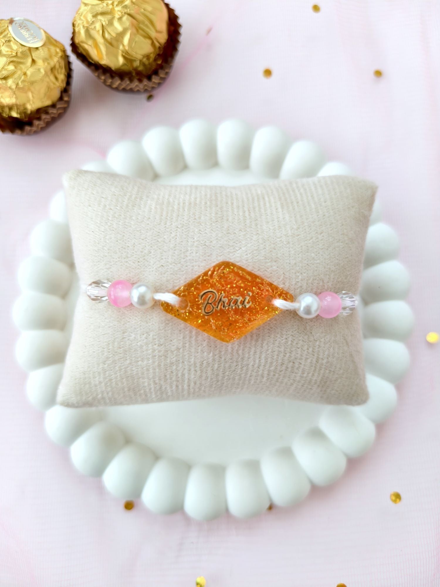 handmade orange resin rakhi 2026, sparkle bhai rakhi design