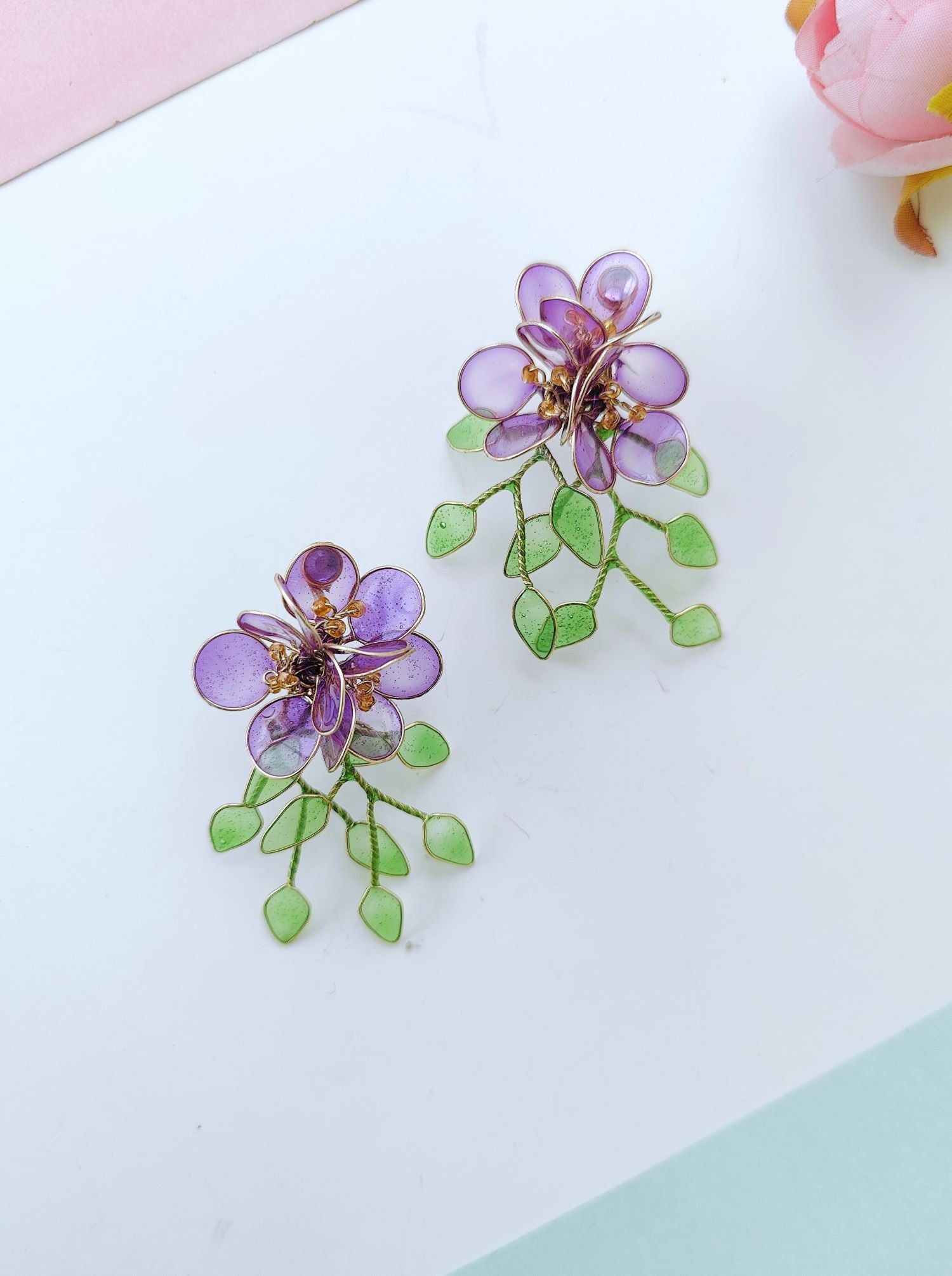Purple floral resin earrings with green leaves, lightweight studs
