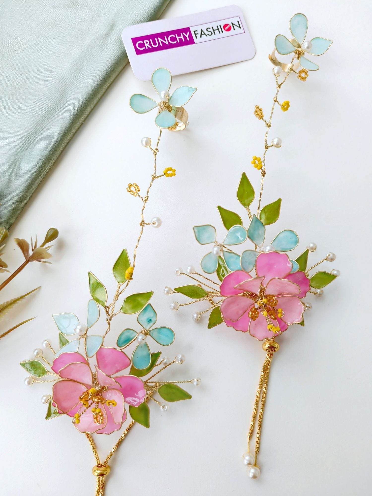 Handmade pastel pink comma powder blue floral resin jewellery with gold plating for brides at haldi & mehndi.