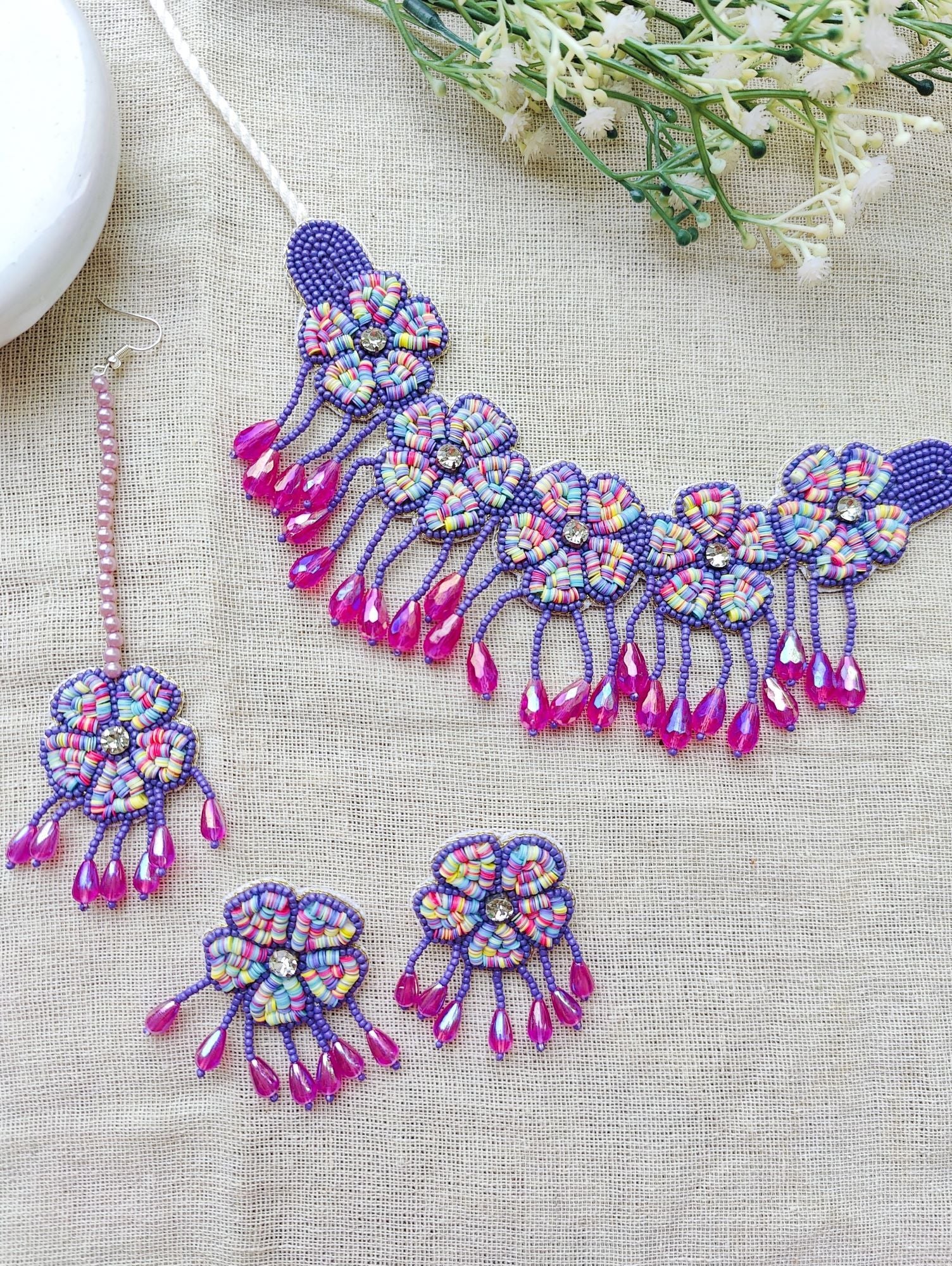 Multicolor handmade jewellery set, ideal for haldi and wedding occasions. Includes mirror work and beaded design, part of the HANDICRAFT collection.