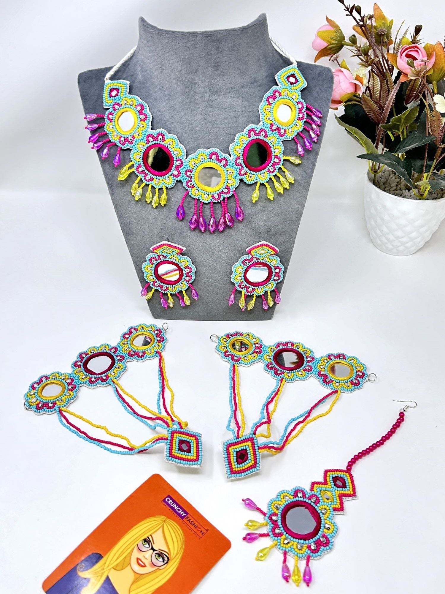 Image of a multicolored, handcrafted bridal jewellery set for women with floral designs. The beaded and pearl set is ideal for wedding, haldi, and mehndi occasions.