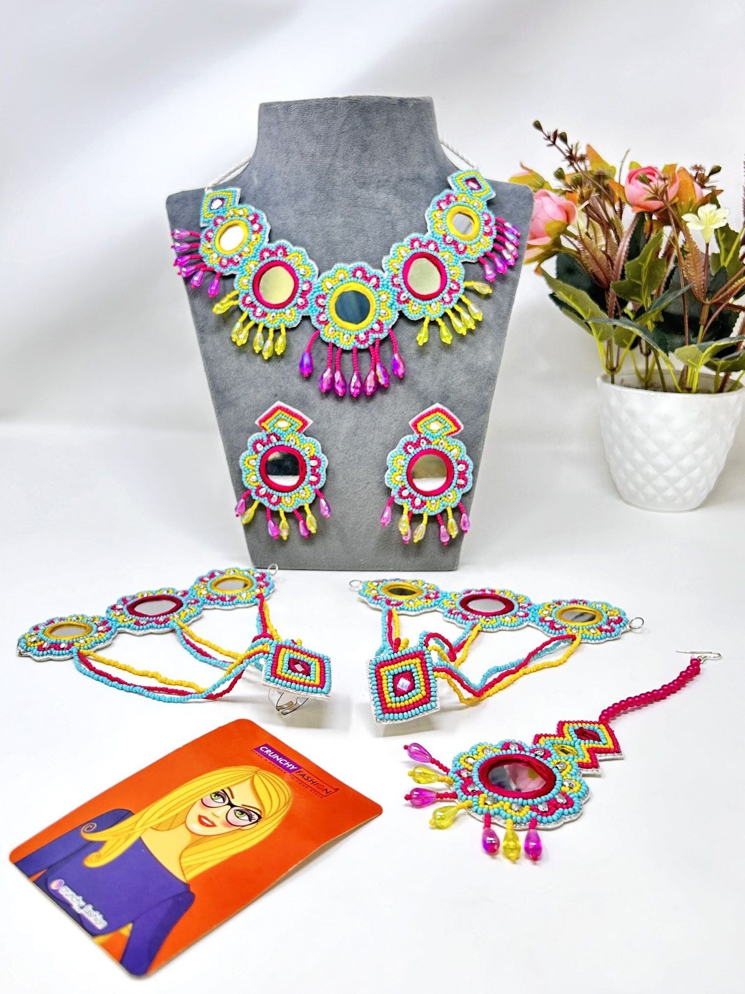 Image of a multicolored, handcrafted bridal jewellery set for women with floral designs. The beaded and pearl set is ideal for wedding, haldi, and mehndi occasions.