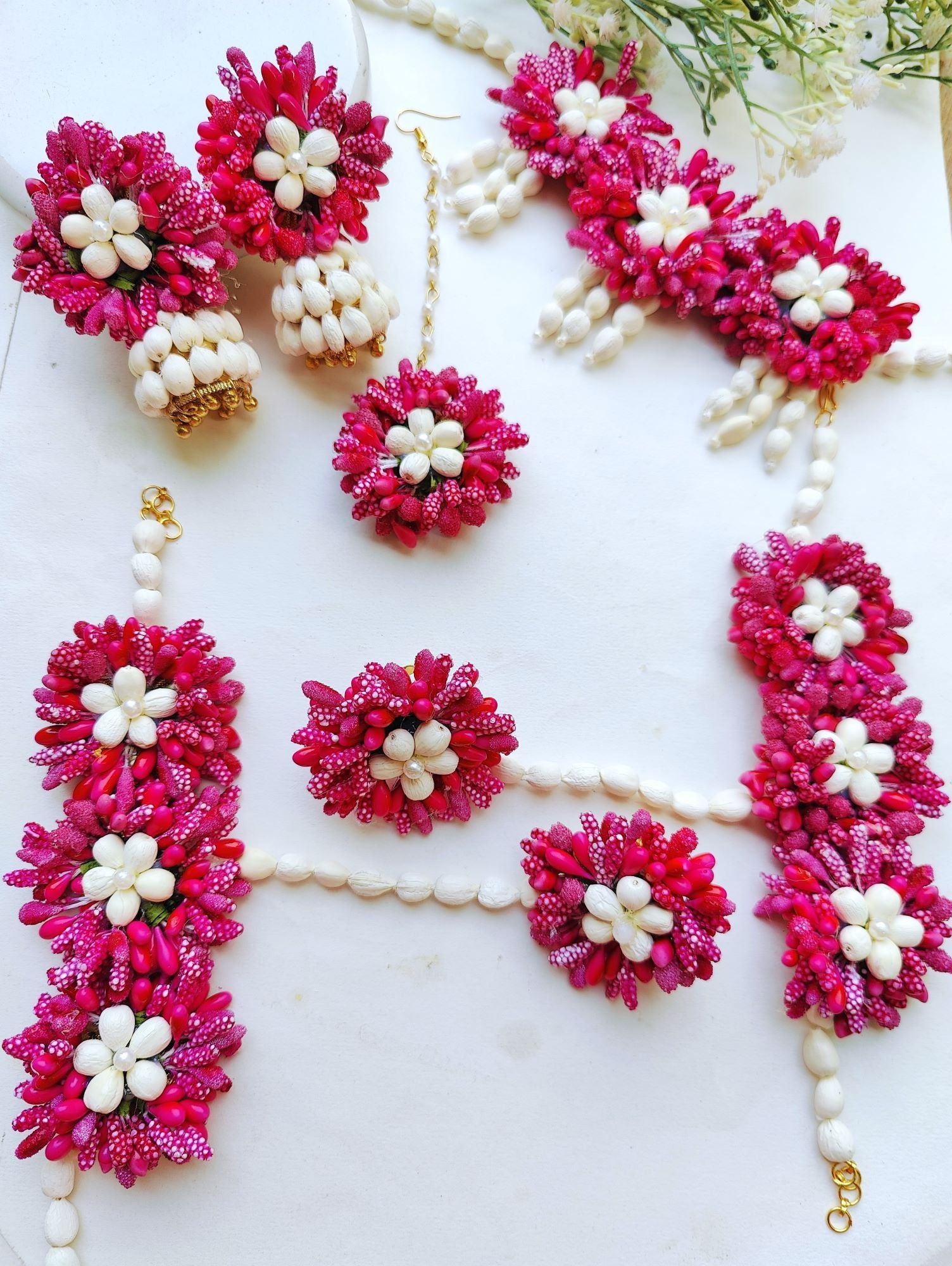 Pink multicolored floral Haldi jewellery set perfect for weddings, gift, Haldi, and Mehandi occasions. Ideal for women's ethnic collection.