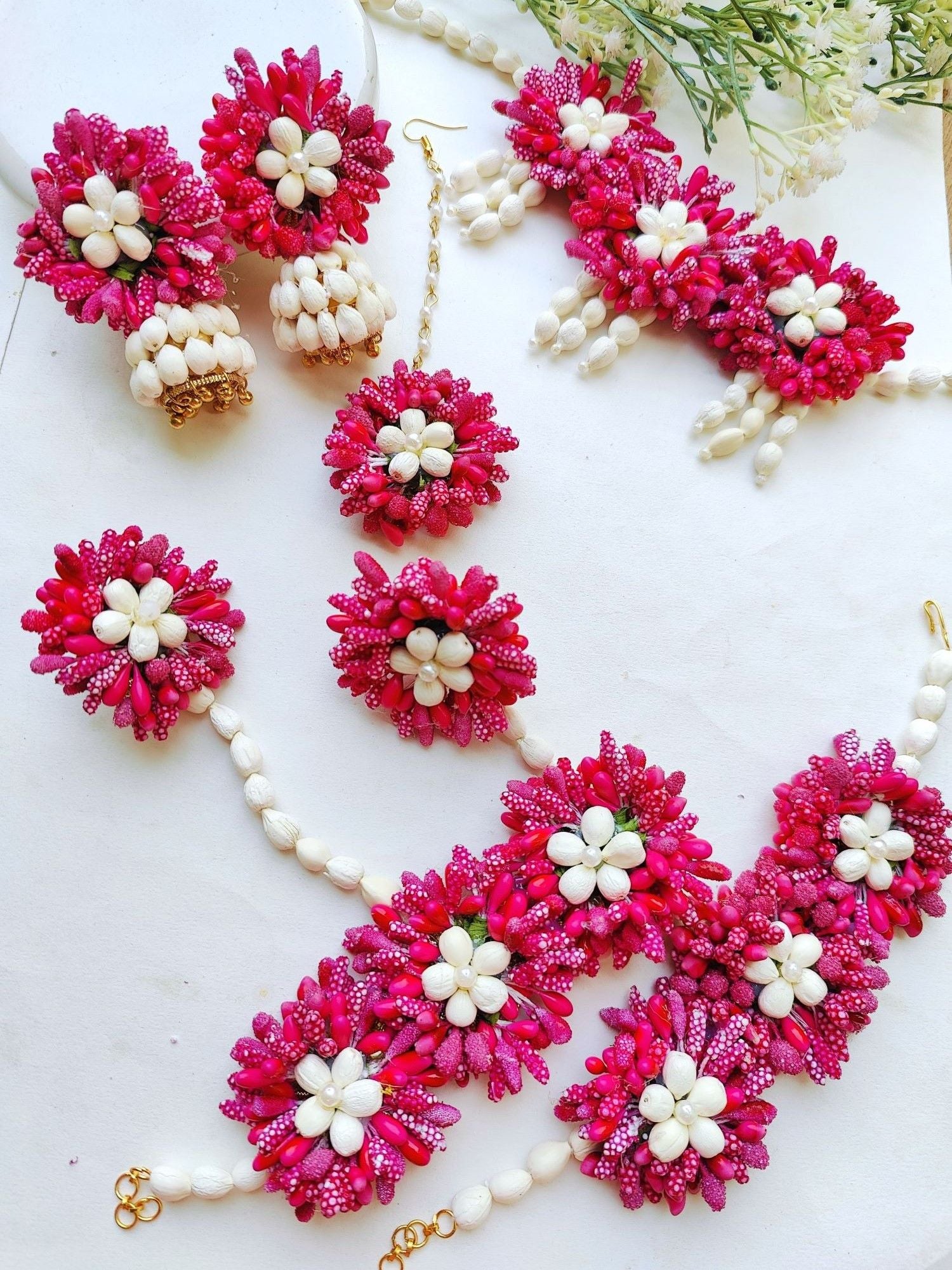 Pink multicolored floral Haldi jewellery set perfect for weddings, gift, Haldi, and Mehandi occasions. Ideal for women's ethnic collection.