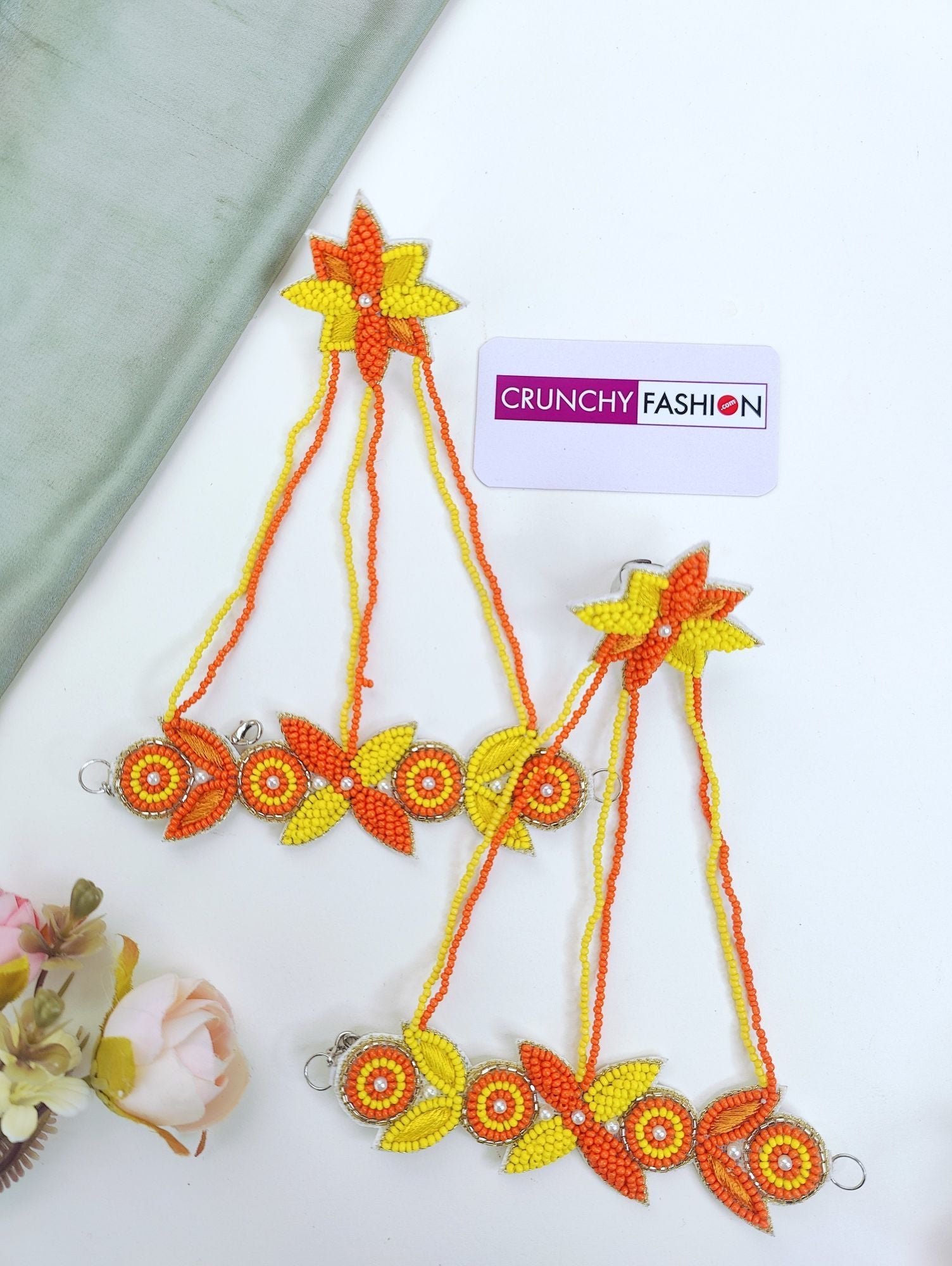Handmade yellow-orange beaded and pearl bridal jewellery set with floral theme for haldi-mehndi celebration