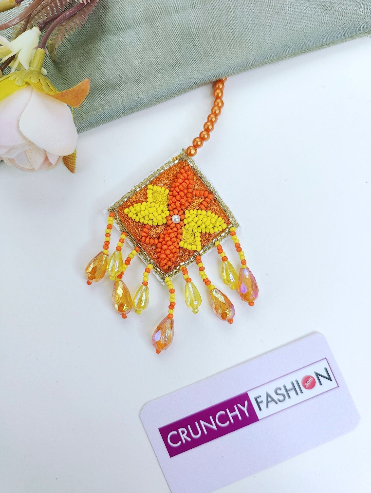 Handmade yellow-orange beaded and pearl bridal jewellery set with floral theme for haldi-mehndi celebration