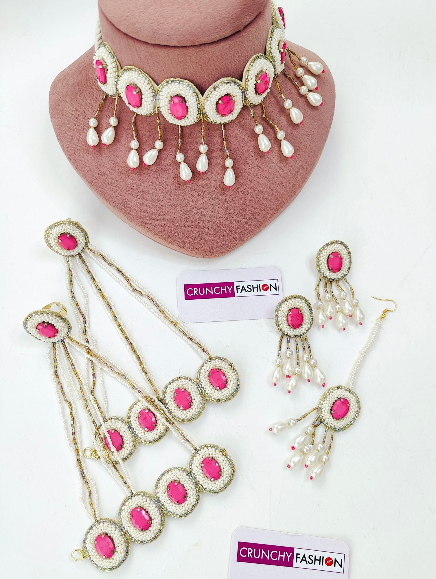Handcrafted pink crystal pearl bridal jewellery set for haldi-mehndi, including necklace, earrings, maang tika and hathhools