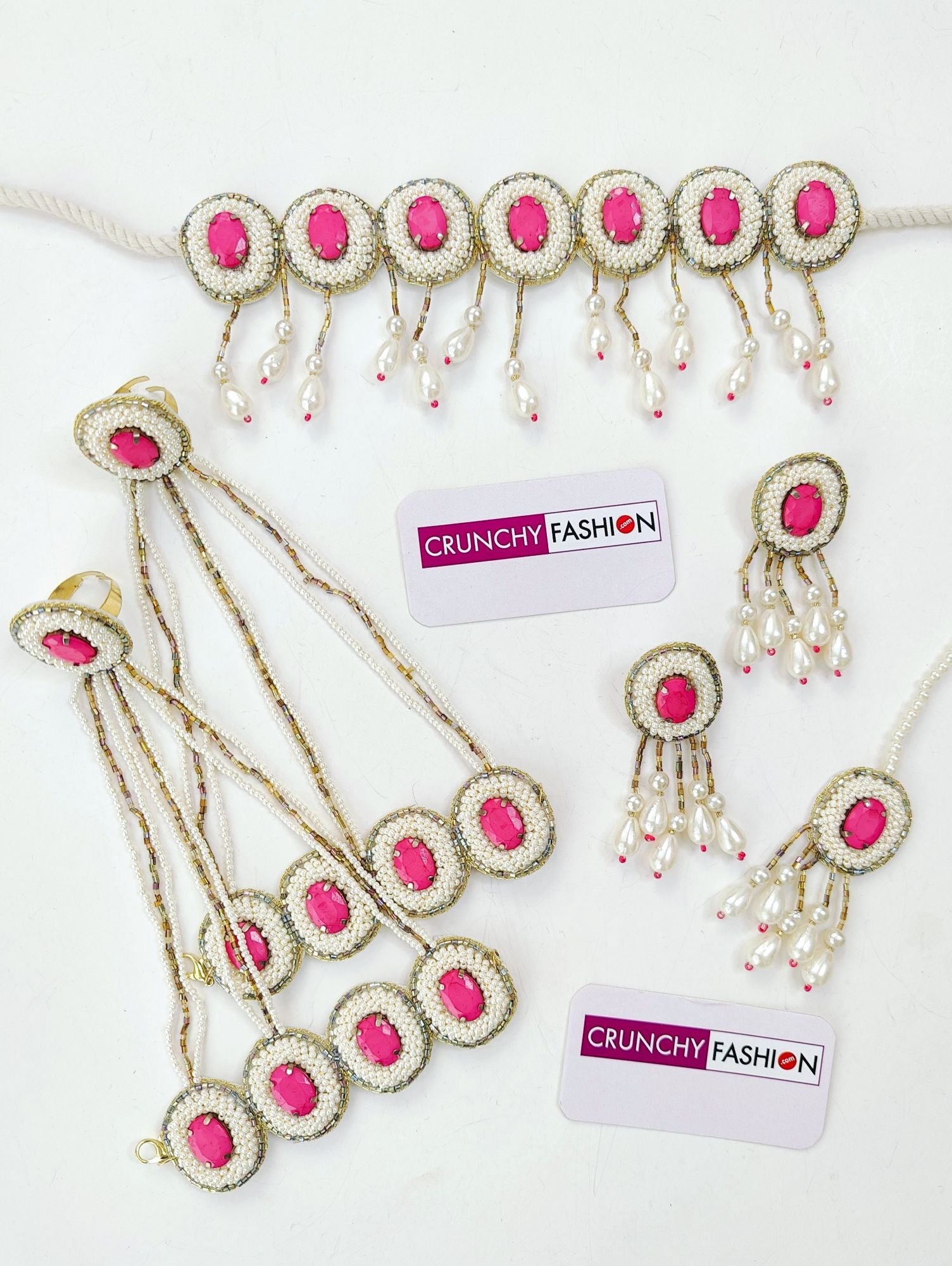 Handcrafted pink crystal pearl bridal jewellery set for haldi-mehndi, including necklace, earrings, maang tika and hathhools