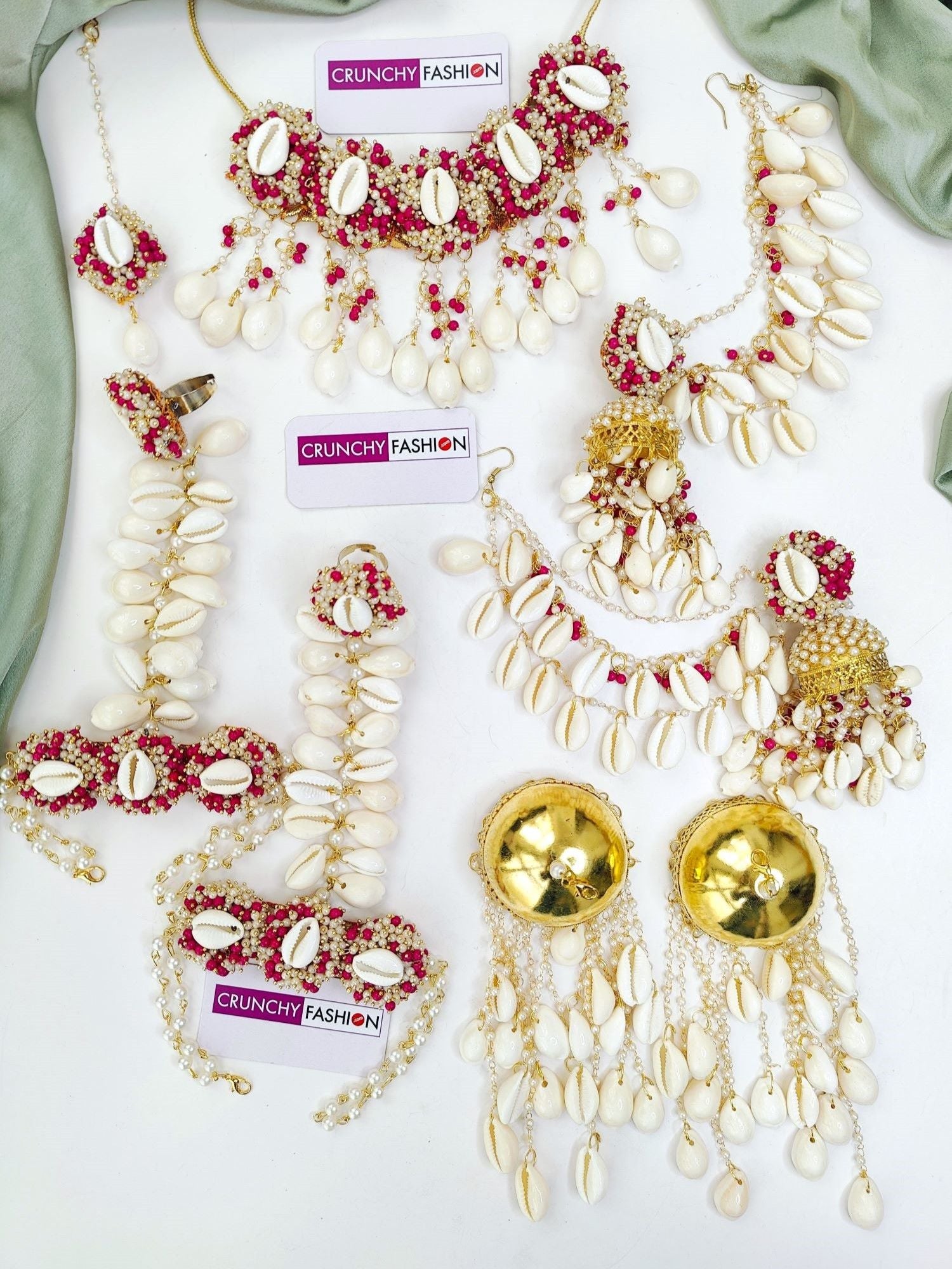 Pink & white gold-plated Haldi Mehndi jewelry set with seashell florals, perfect for festive wear.