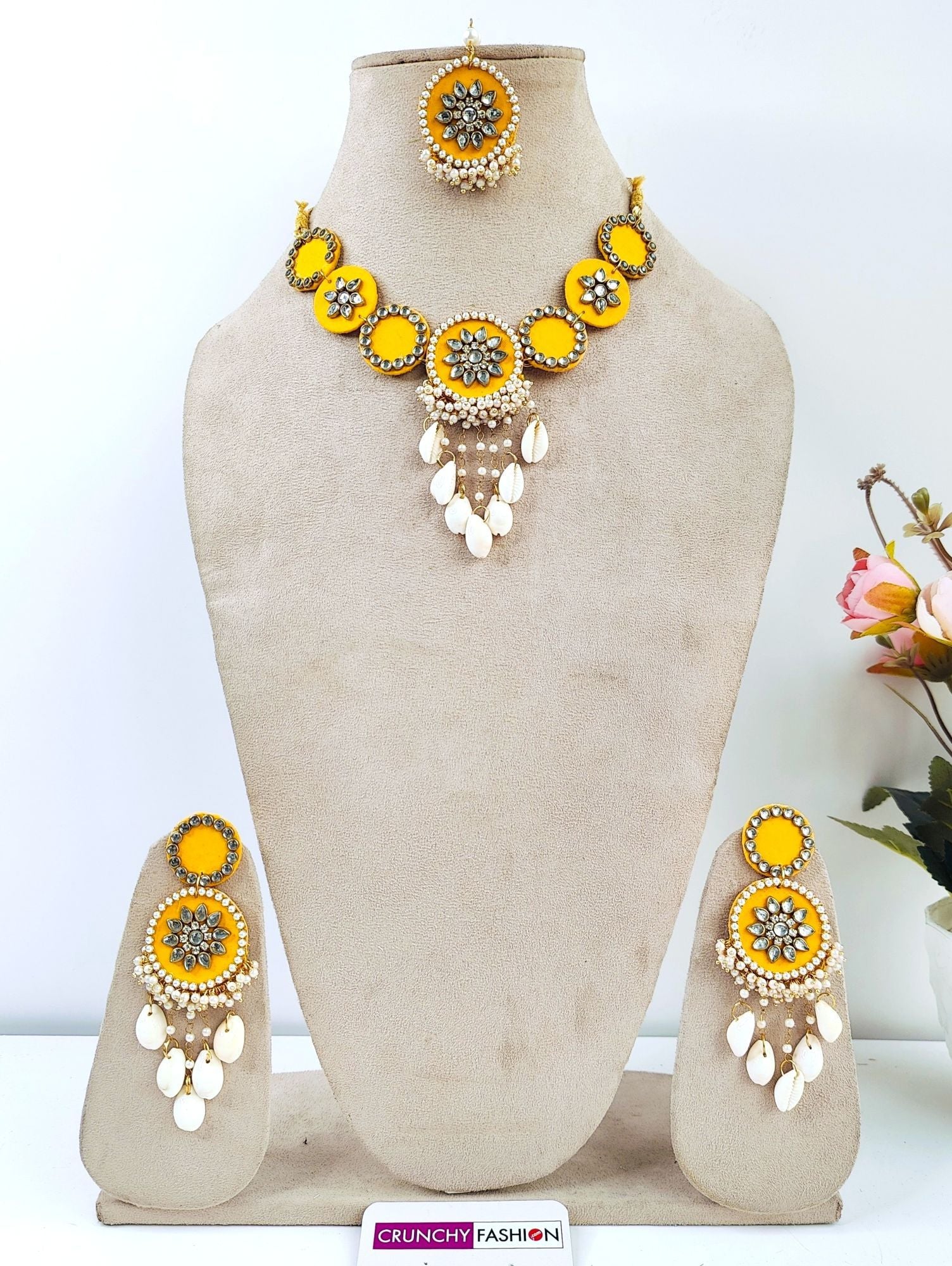 Yellow gold-plated Haldi Mehndi jewellery set with Kundan & shell embellishments, Kaliras; ideal for celebrations.