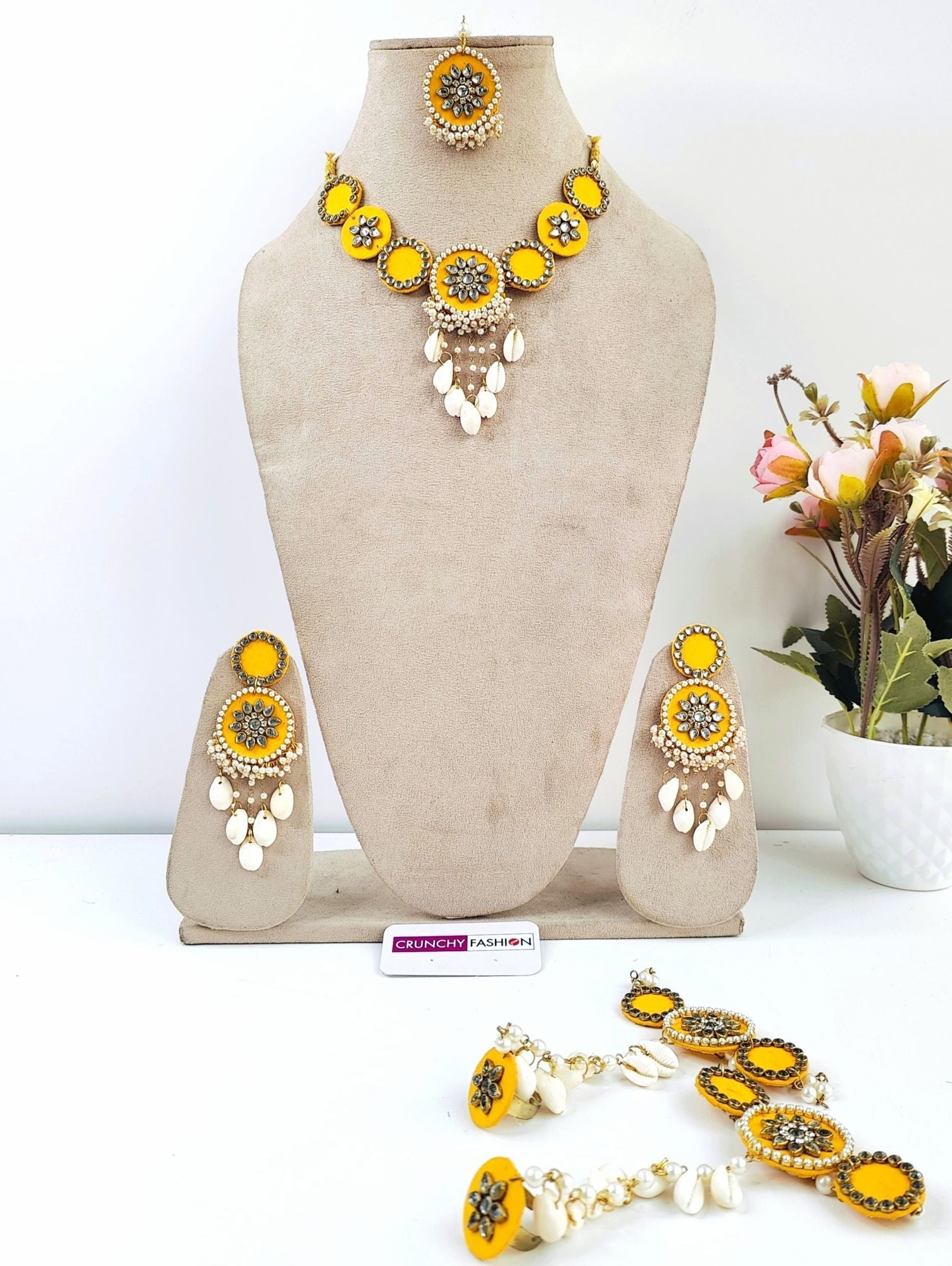 Yellow gold-plated Haldi Mehndi jewellery set with Kundan & shell embellishments, Kaliras; ideal for celebrations.