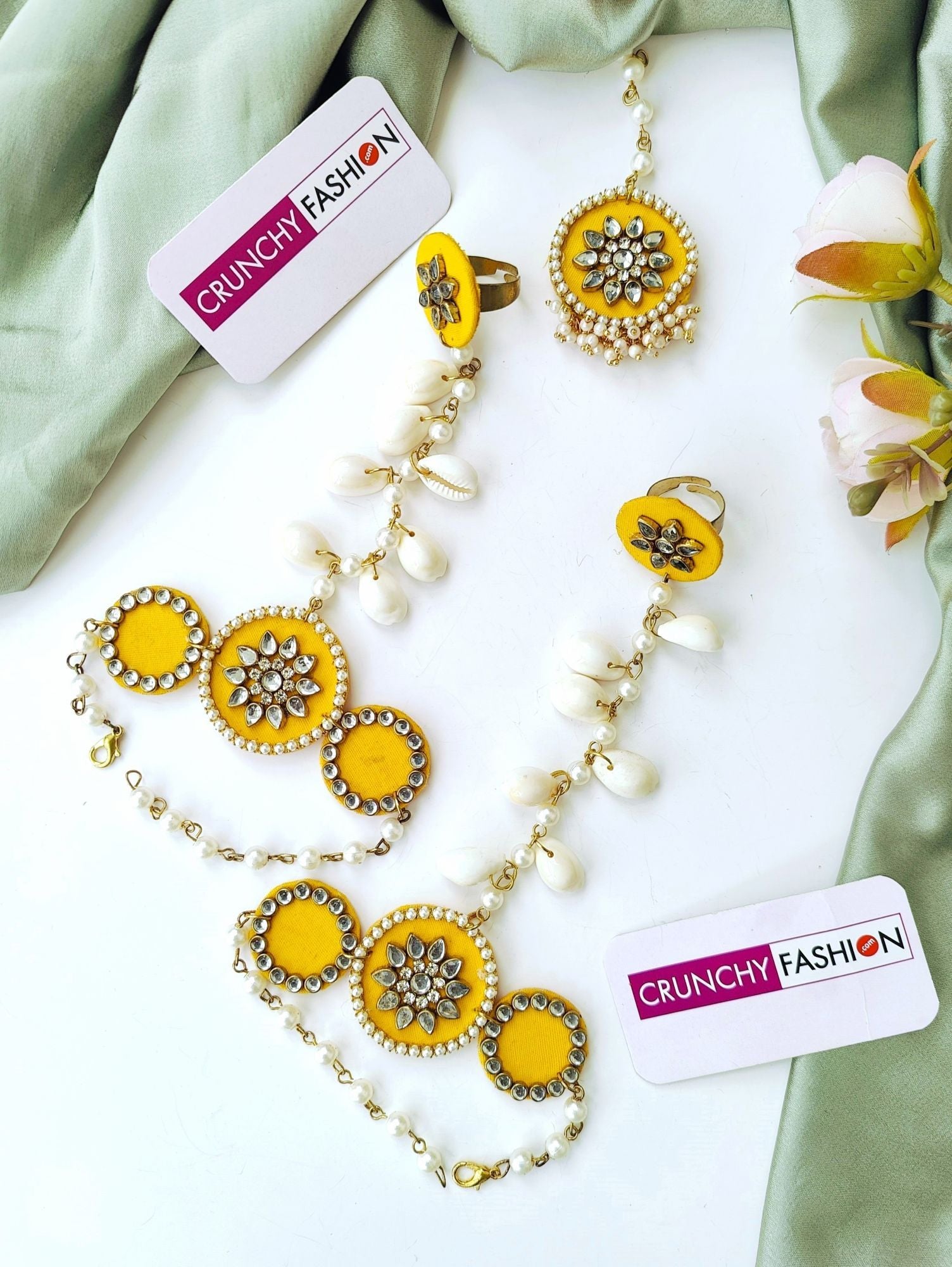 Yellow gold-plated Haldi Mehndi jewellery set with Kundan & shell embellishments, Kaliras; ideal for celebrations.