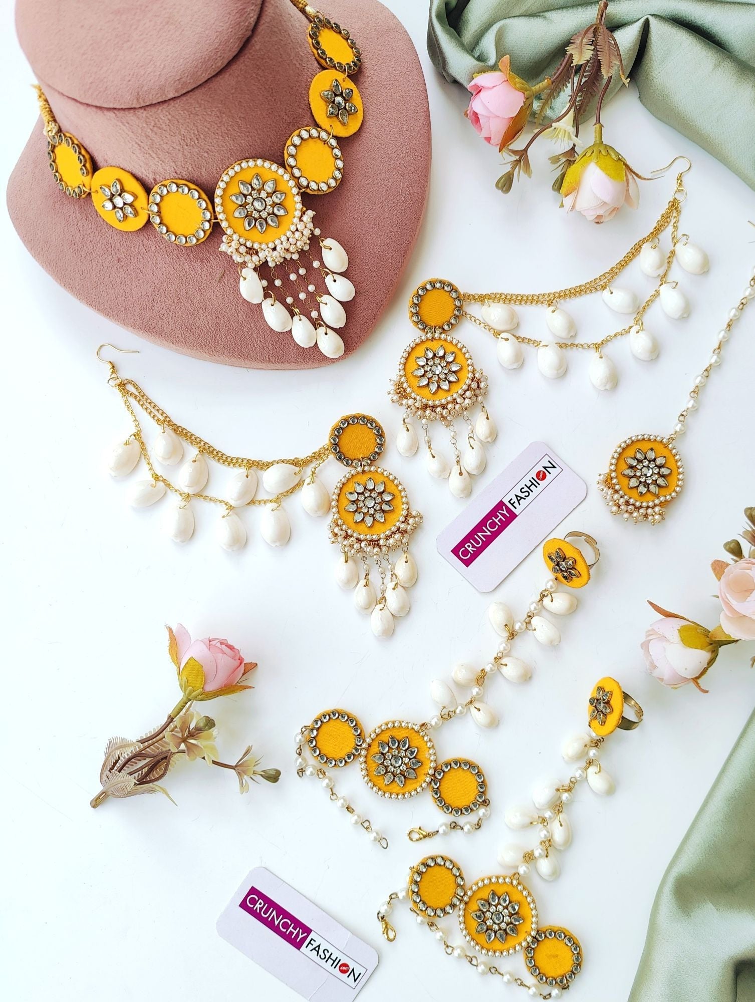 Yellow gold-plated Haldi Mehndi jewellery set with Kundan & shell embellishments, Kaliras; ideal for celebrations.