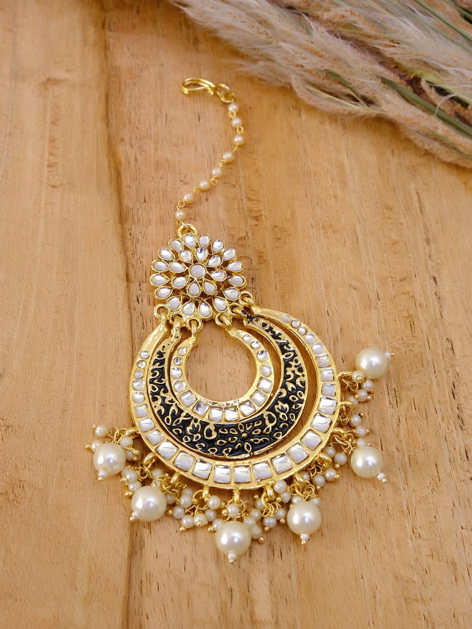 Gold-black alloy ethnic maang tikka with an asymmetric tikka design, ideal festive jewellery piece for women